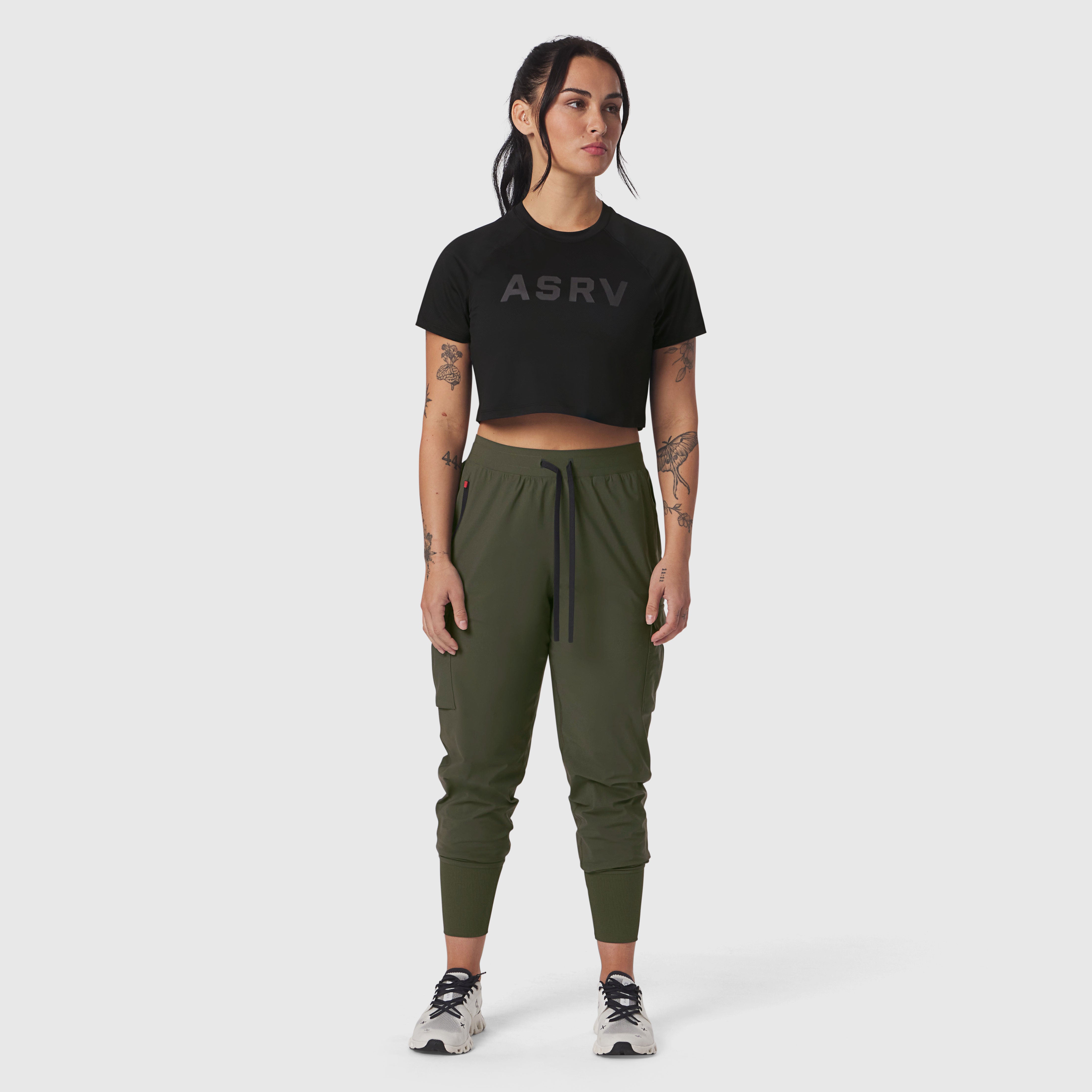 Black ASRV cropped tee with logo, styled with olive cargo joggers and sneakers