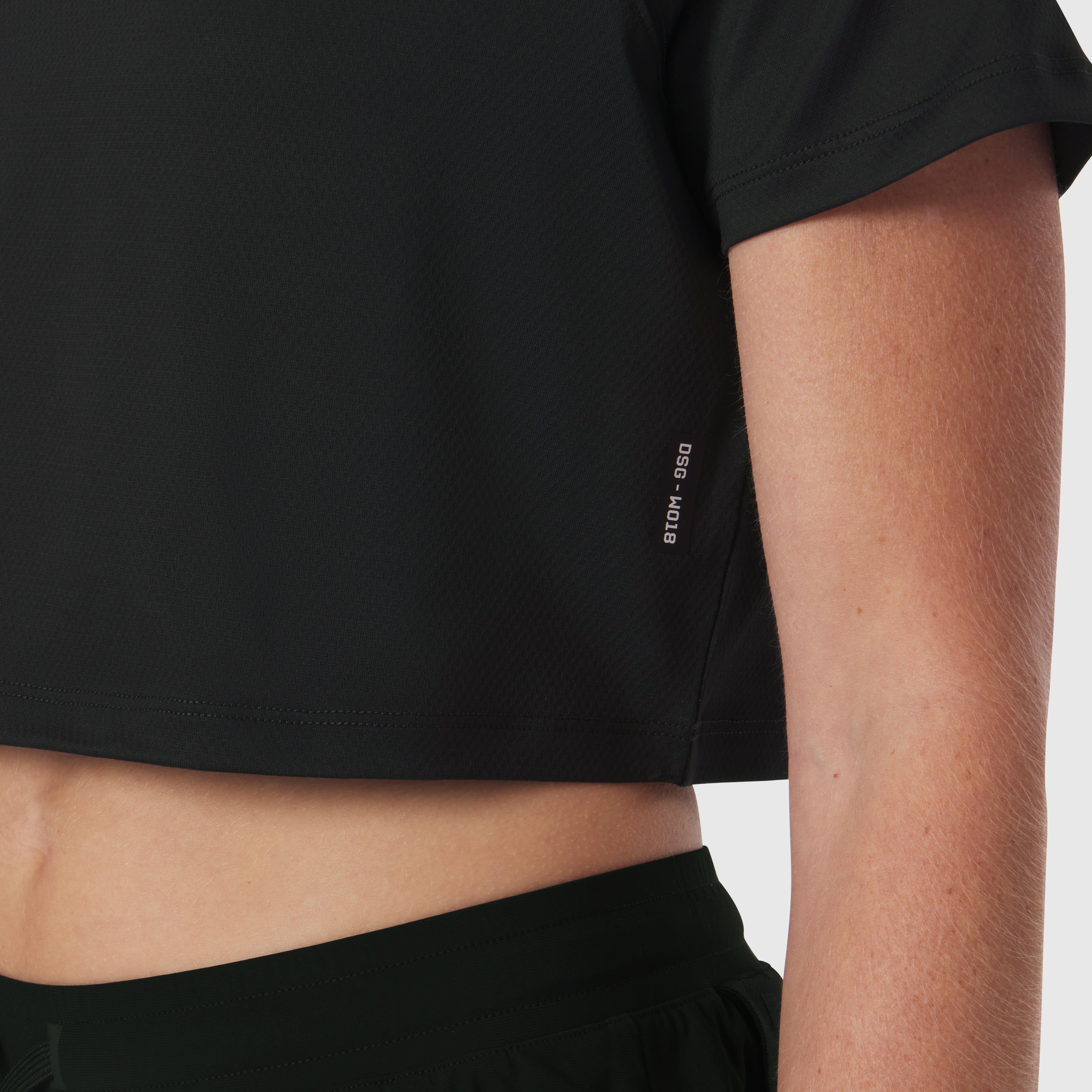 AeroSilver® Cropped Tee in black, worn by model showing side view