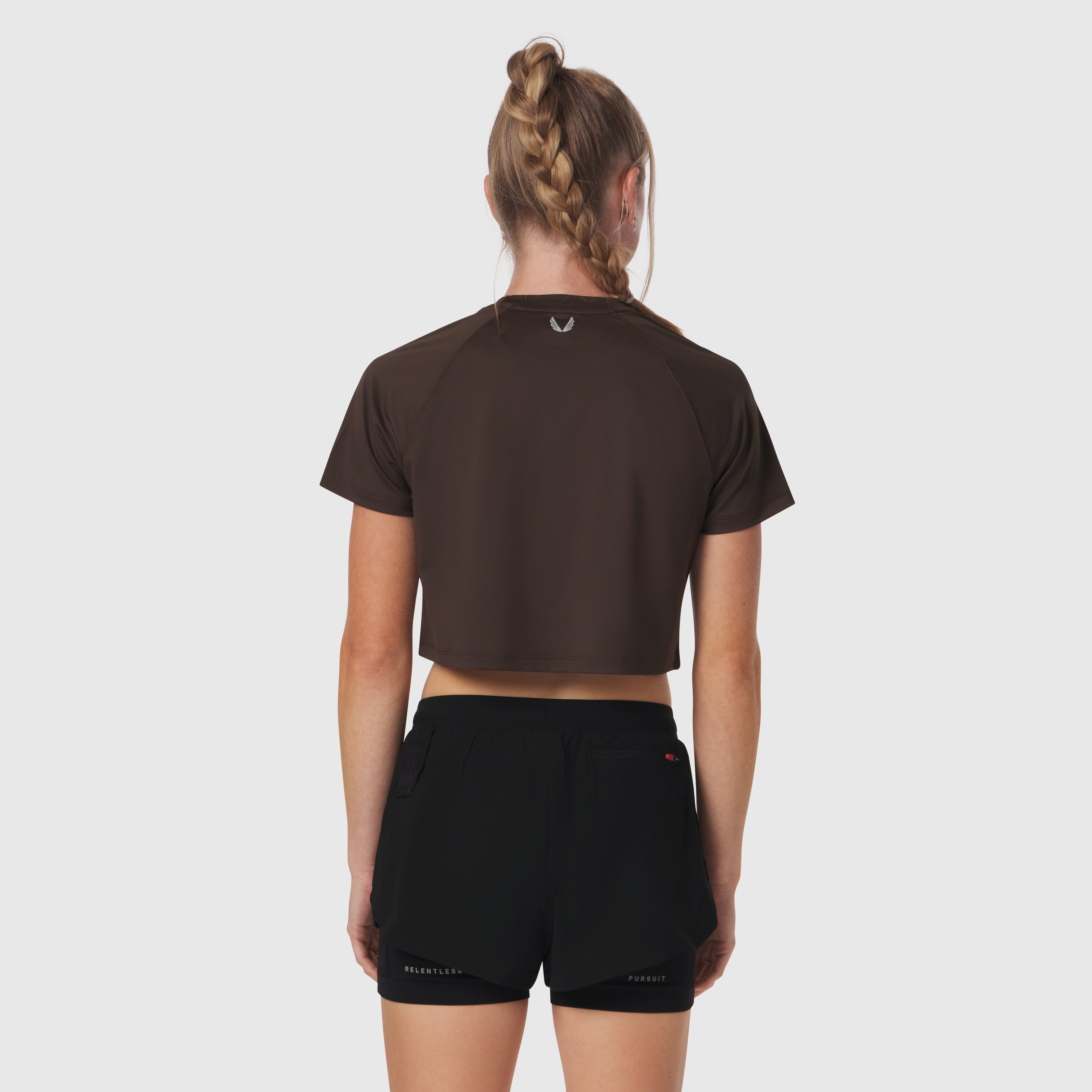 AeroSilver® Cropped Tee in Dark Earth, worn with black shorts, back view