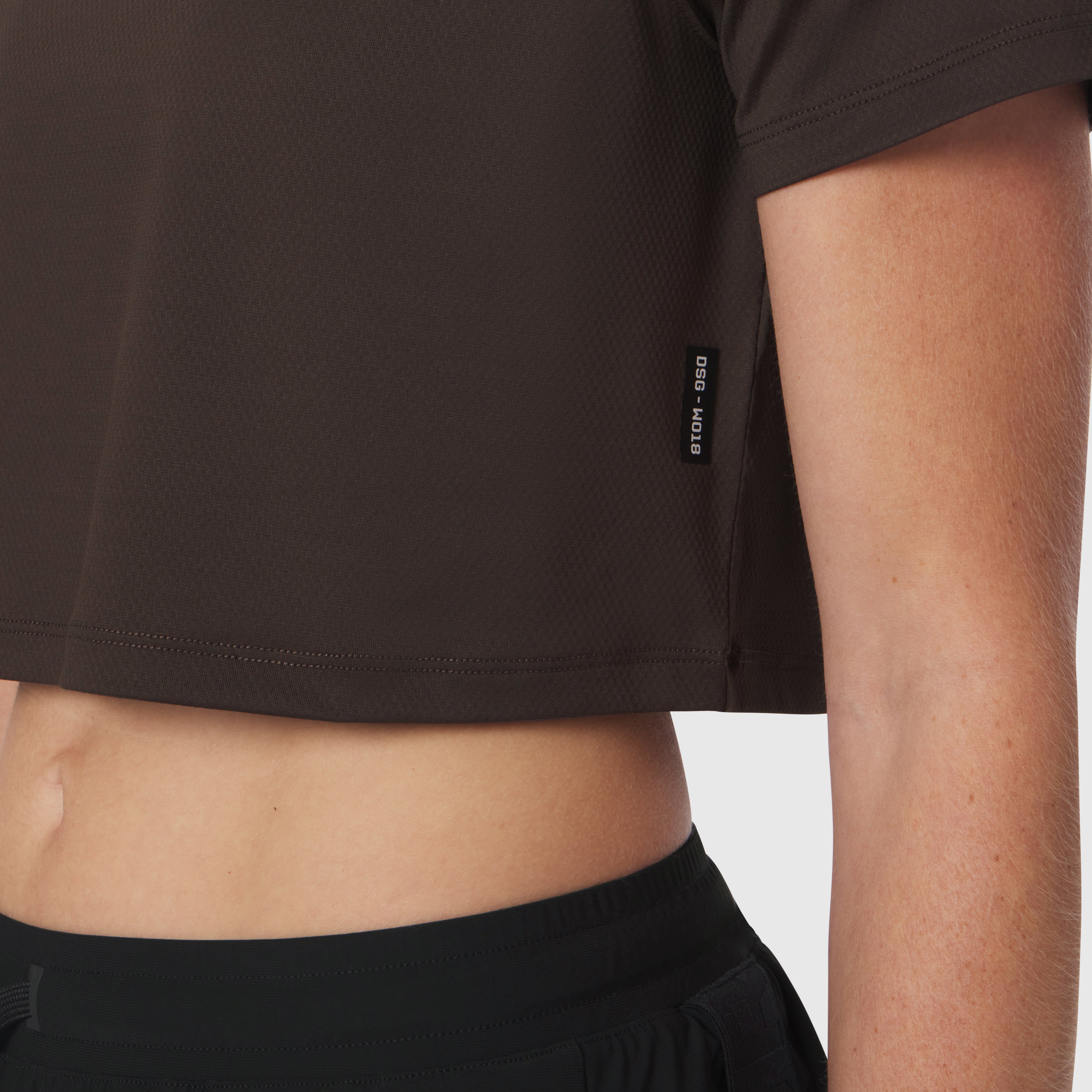 AeroSilver Cropped Tee in Dark Earth worn by model, front detail view