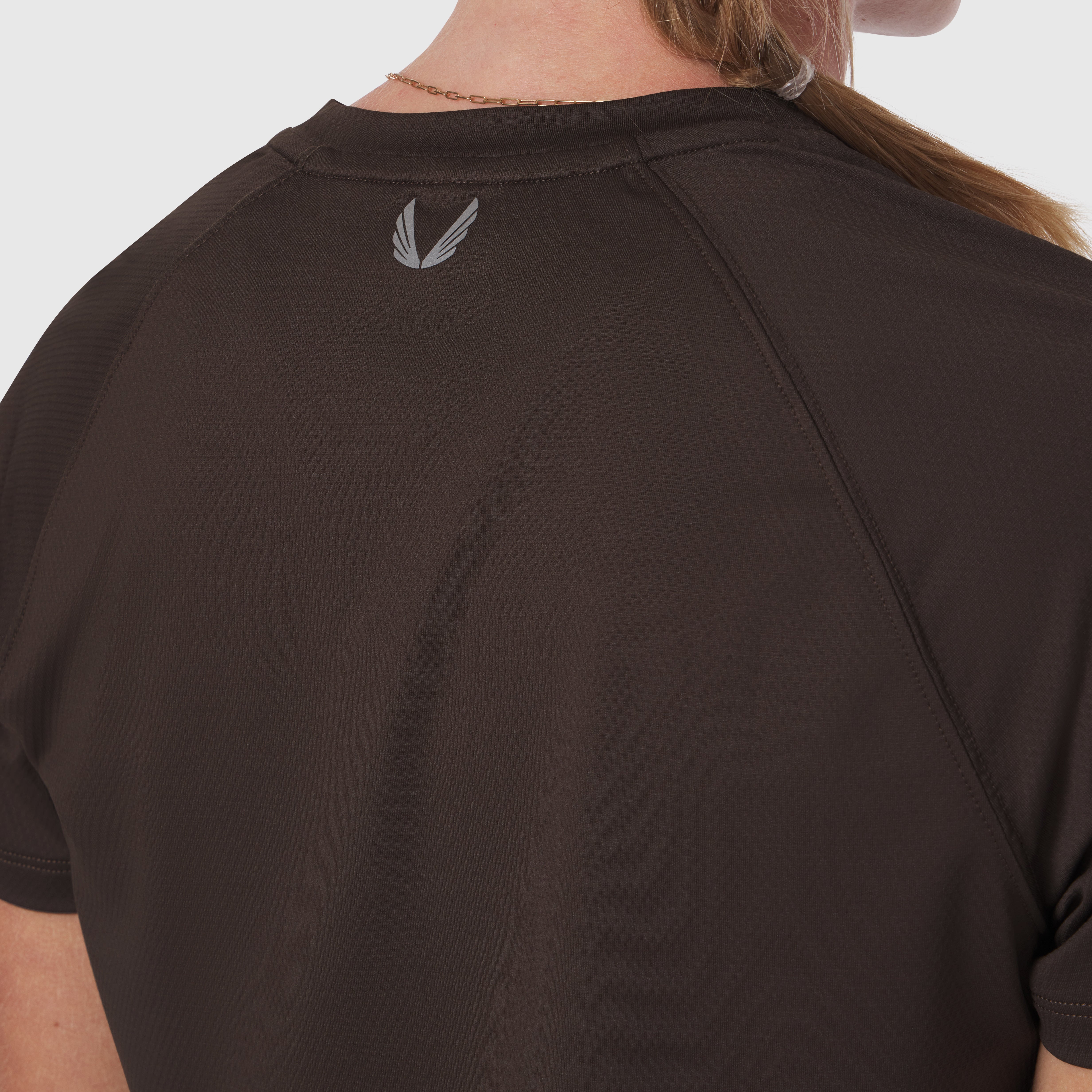 AeroSilver® Cropped Tee in Dark Earth, back view on model