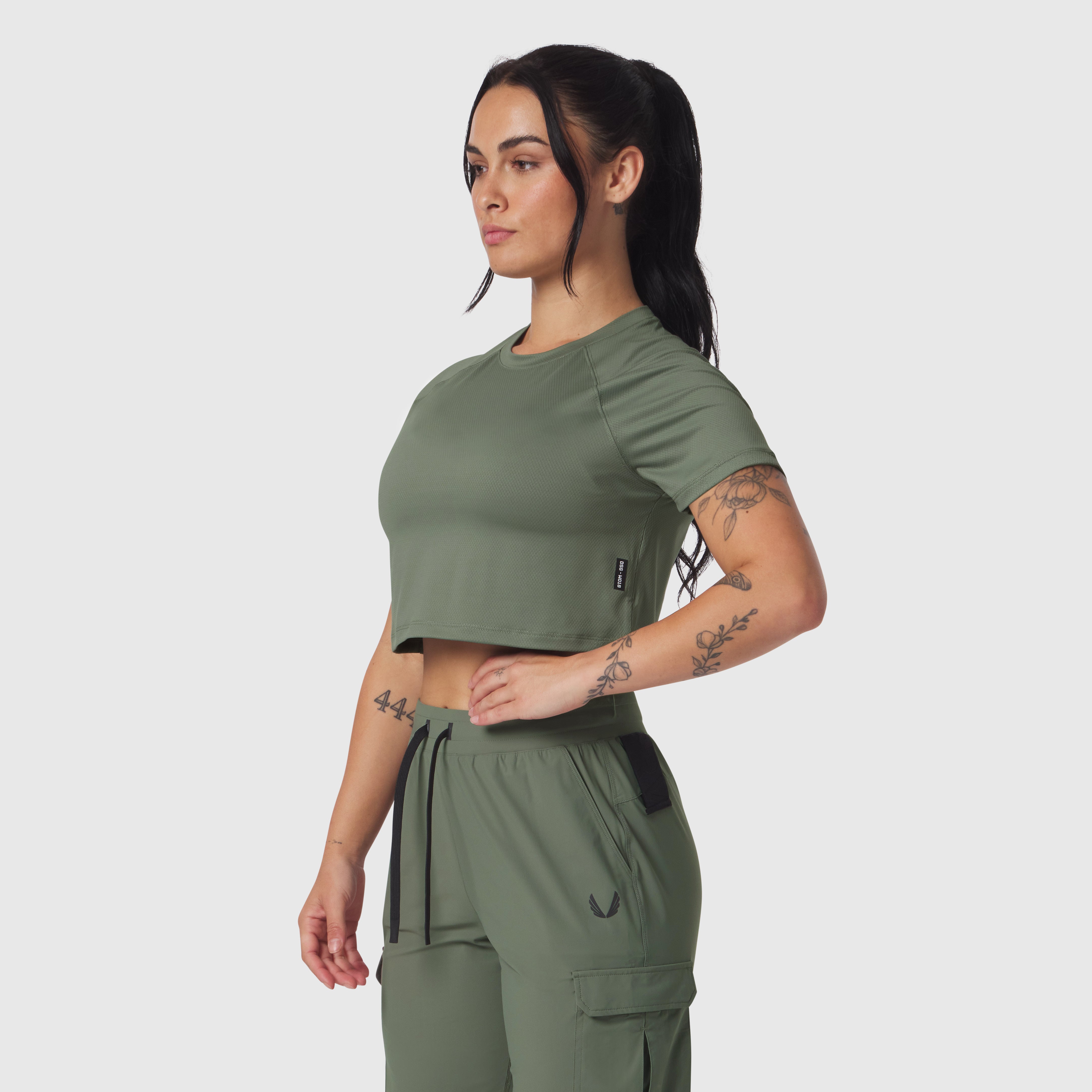 AeroSilver Cropped Tee in sage, worn by model in side profile pose