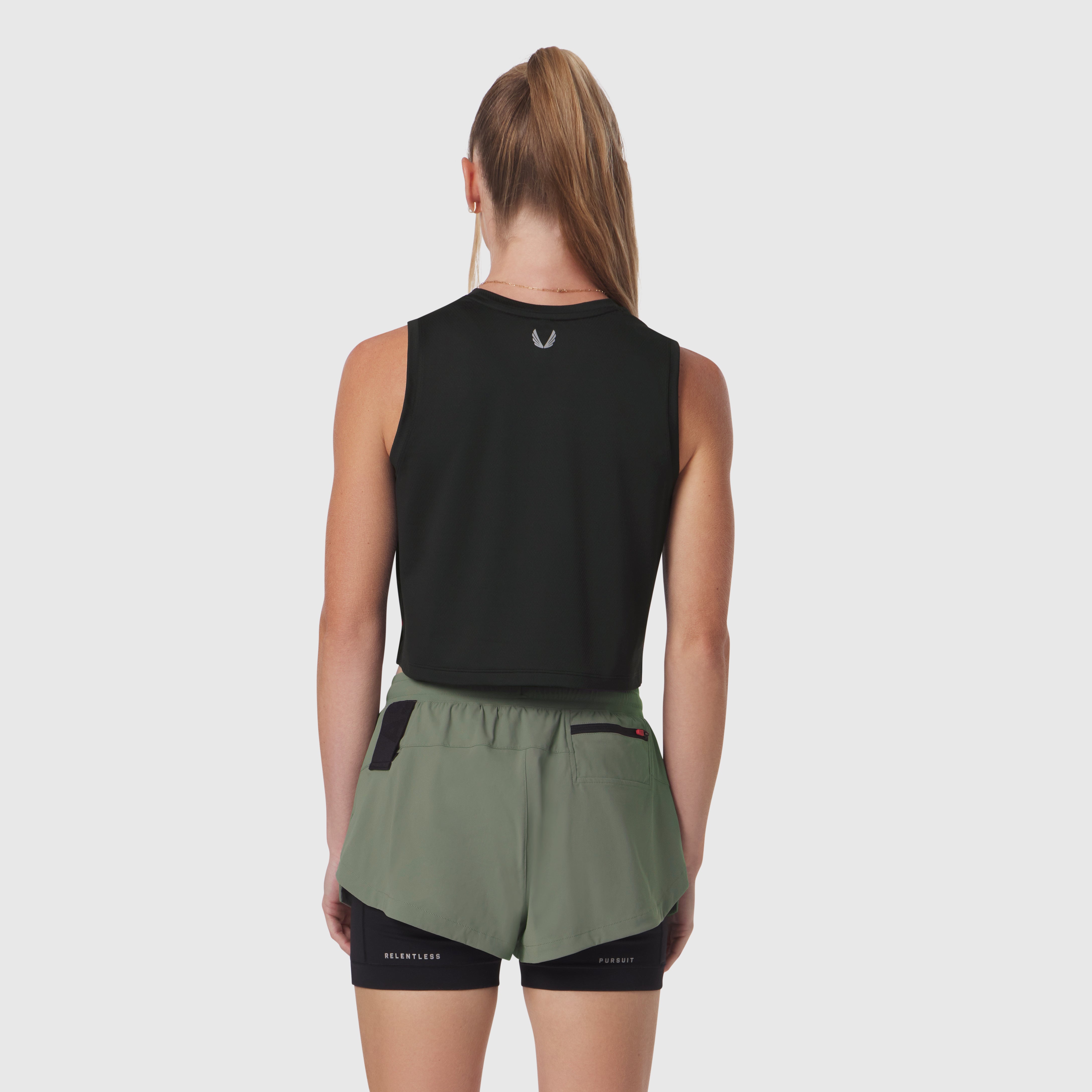 Black AeroSilver tank top and sage green shorts worn by model, back view