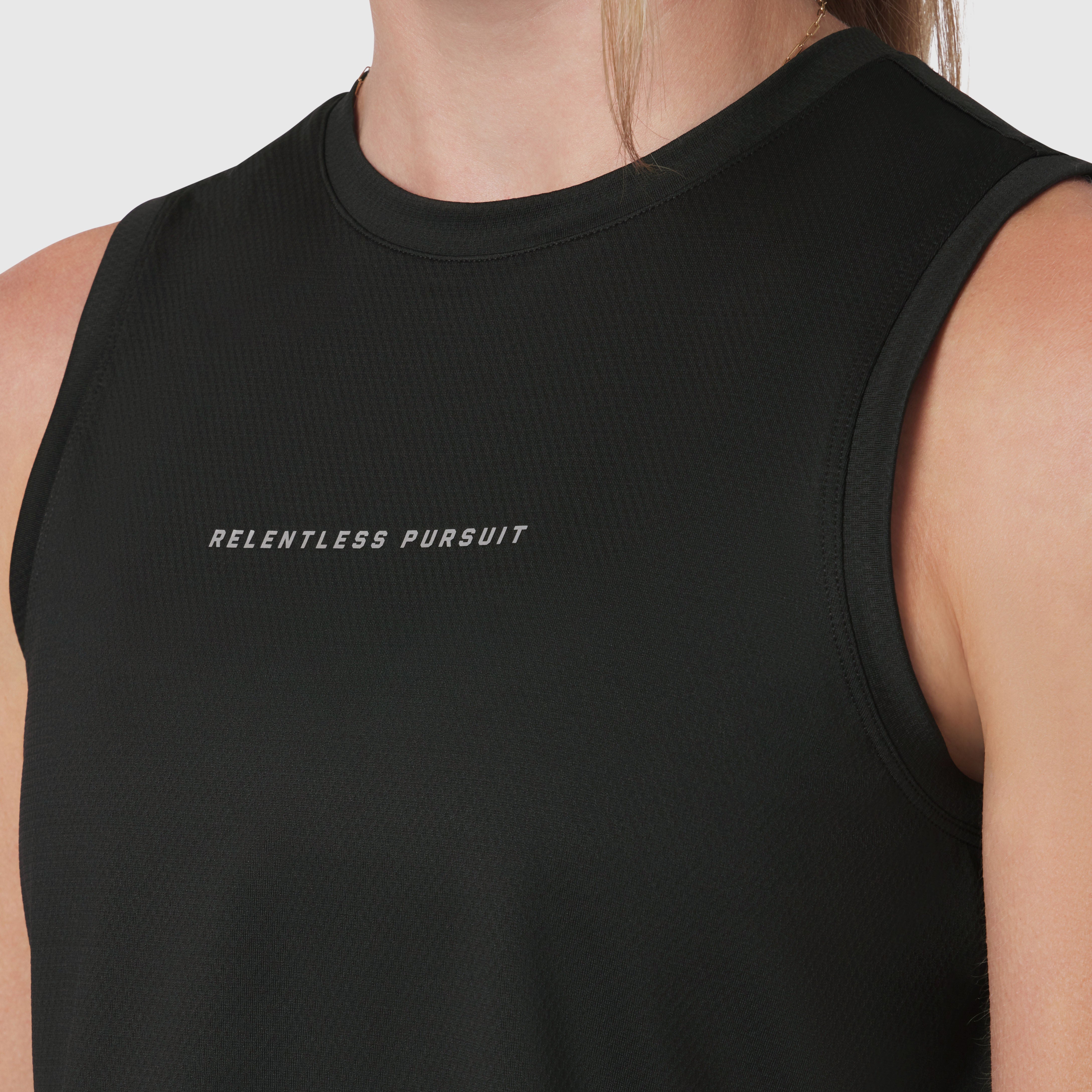 Black AeroSilver Tank Top with 'Relentless Pursuit' text, worn by model, front view