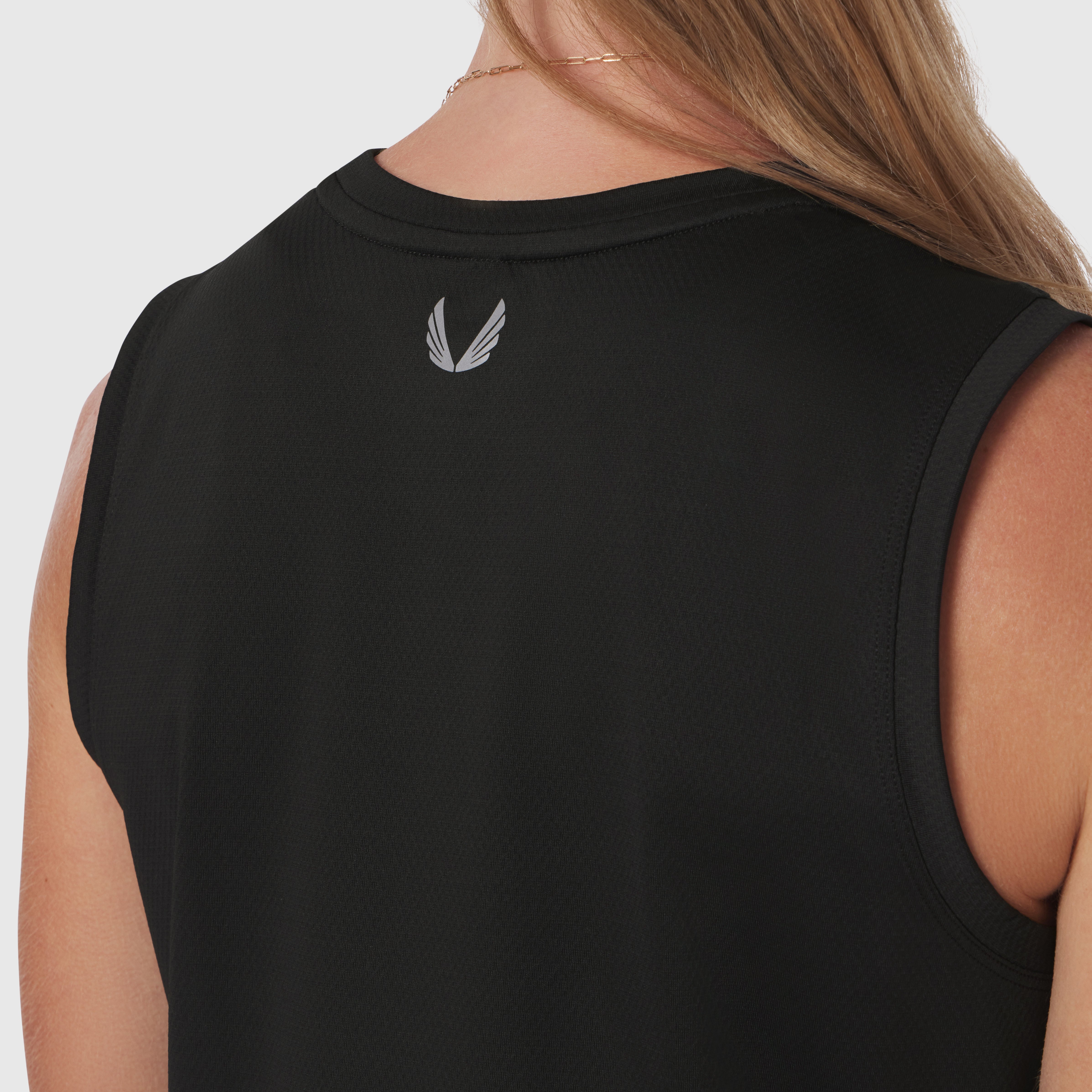 Black AeroSilver® tank top worn by model, back view showing winged logo detail