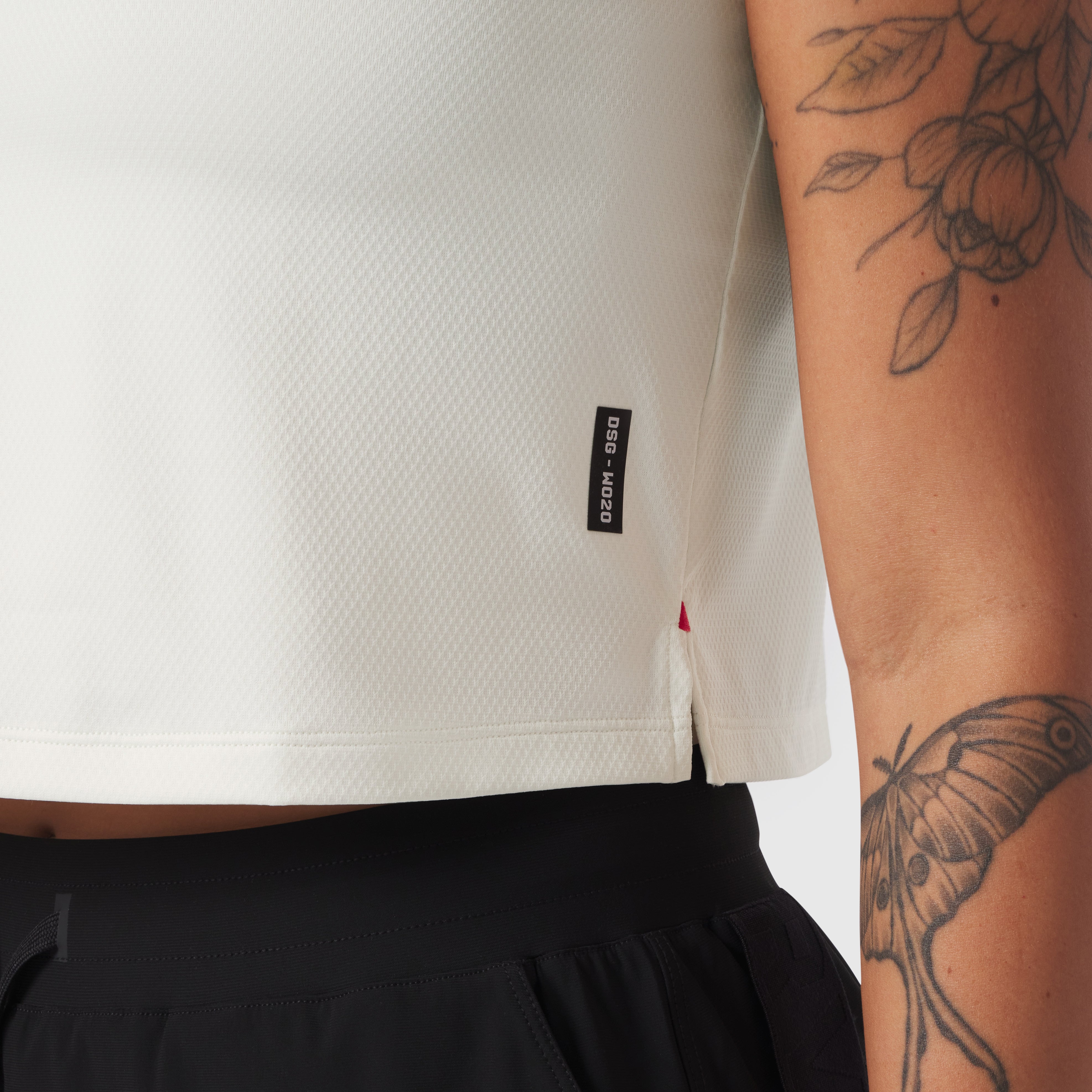 AeroSilver® Tank Top in Ivory Cream worn by model showing side view with tattoos visible