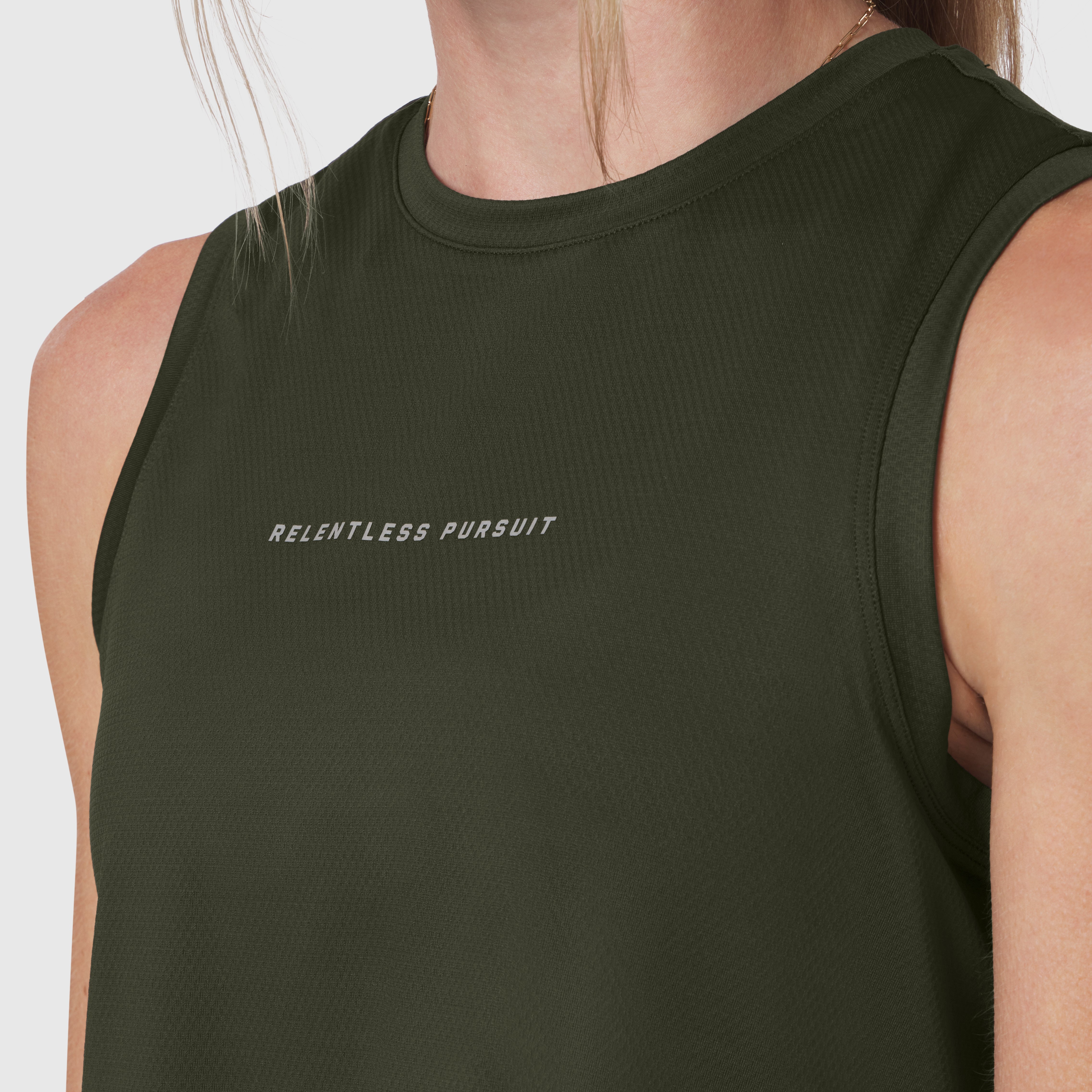 AeroSilver® tank top in olive with 'Relentless Pursuit' text, worn by model