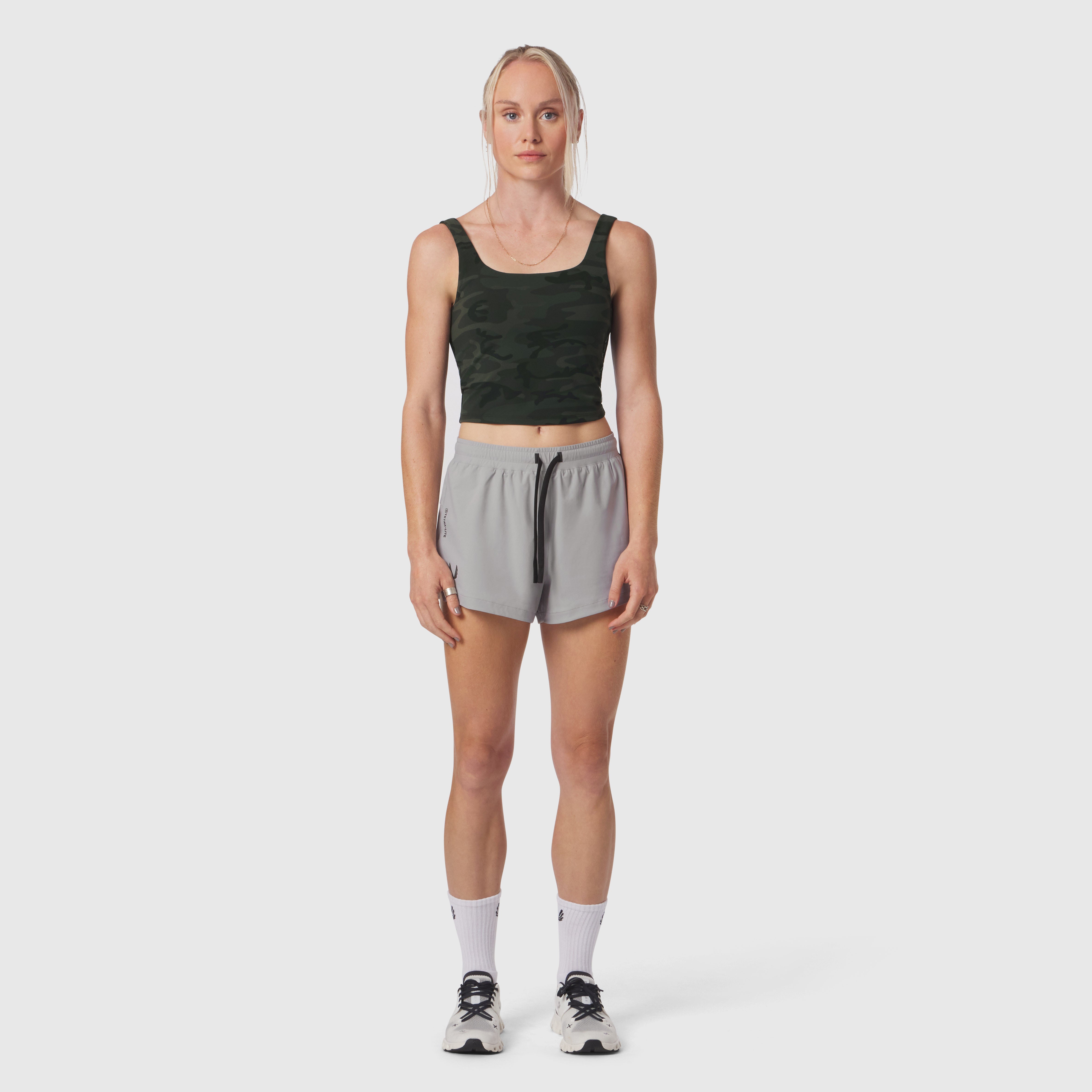 W022 Lycra 2-in-1 tank top in dark camo, worn with grey shorts, front view