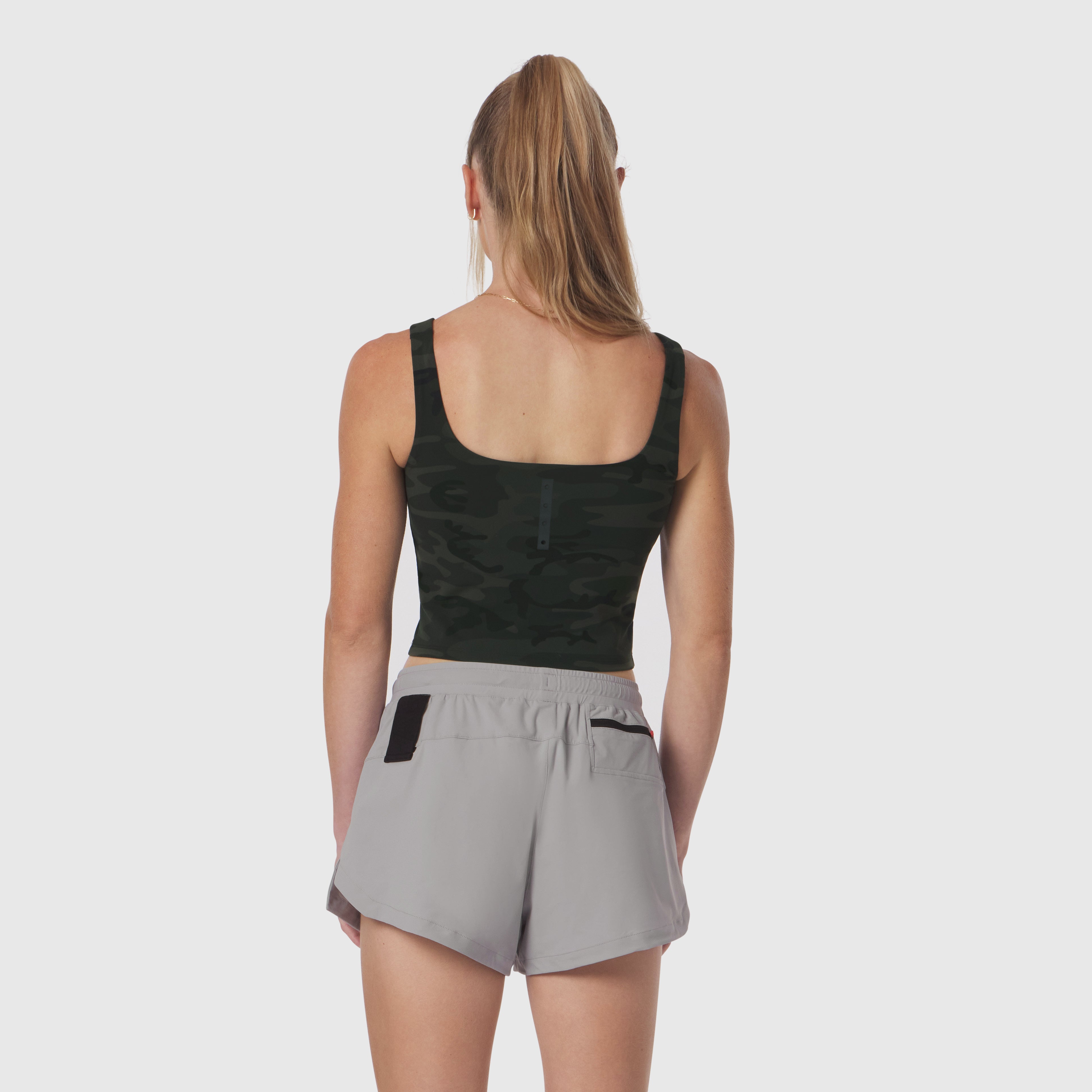 Lycra 2-in-1 tank top in dark camo worn with grey shorts, back view