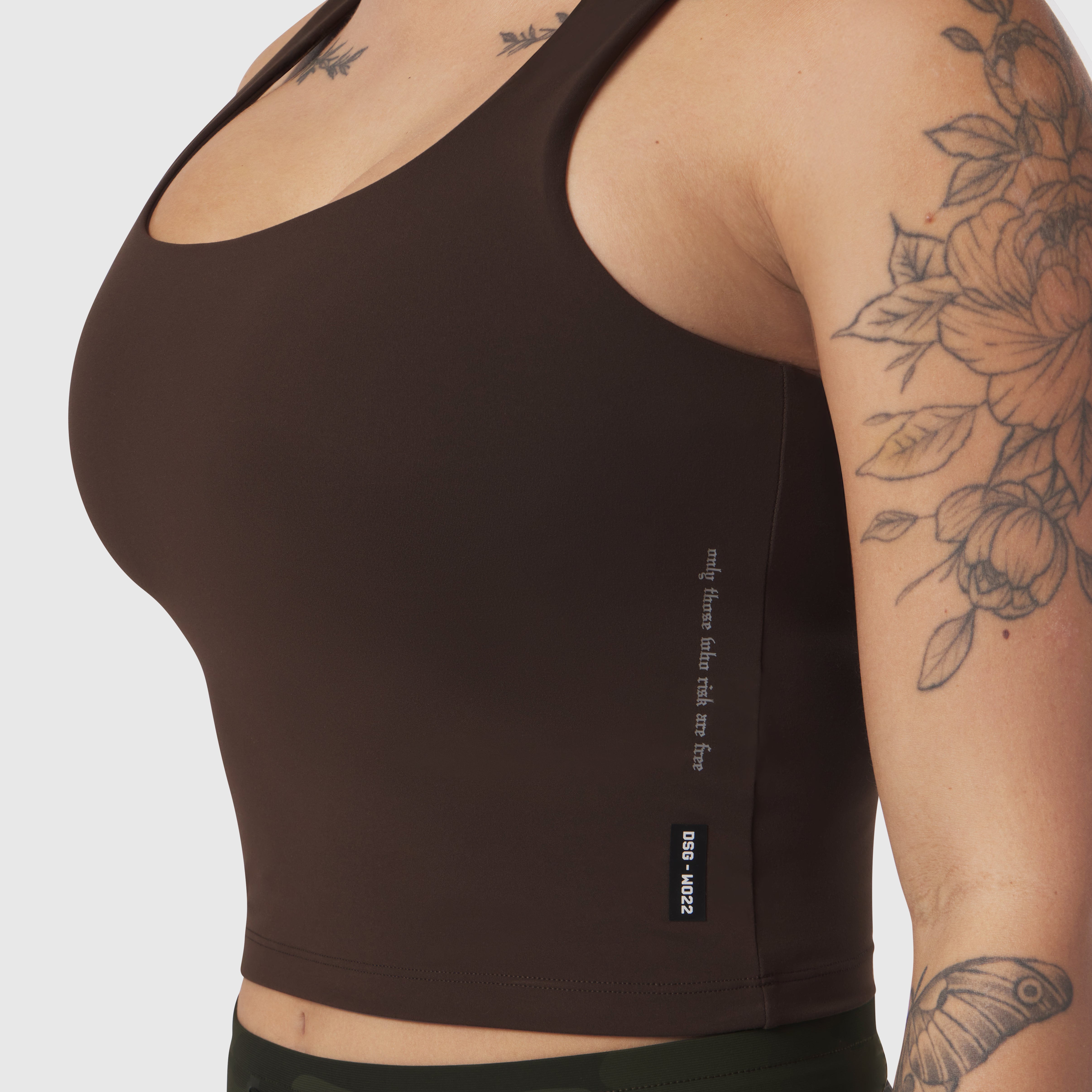 LYCRA® 2-in-1 Tank Top in dark brown, worn by model showing side view with tattoos visible