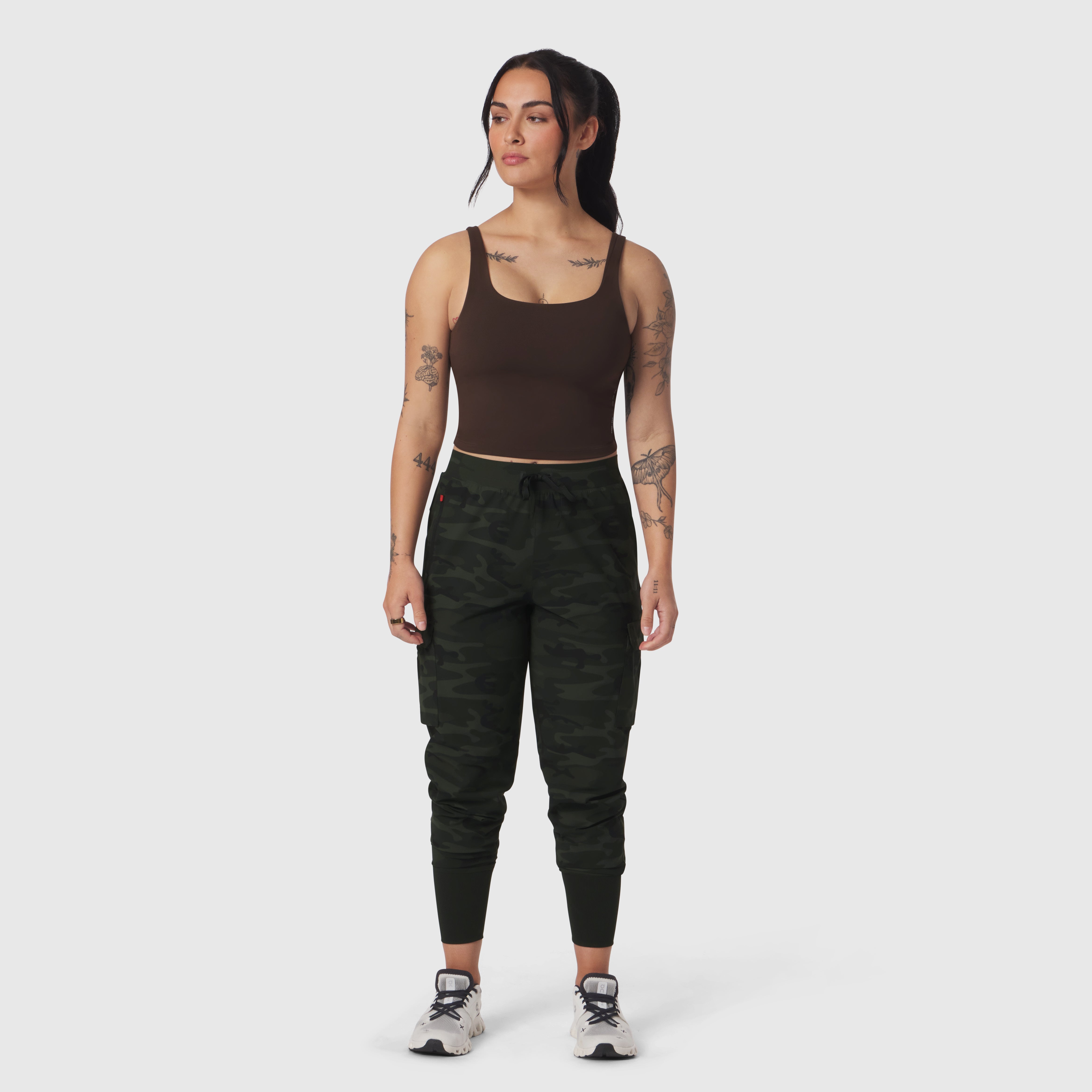 Dark brown LYCRA® 2-in-1 tank top worn with camo joggers, front view on model