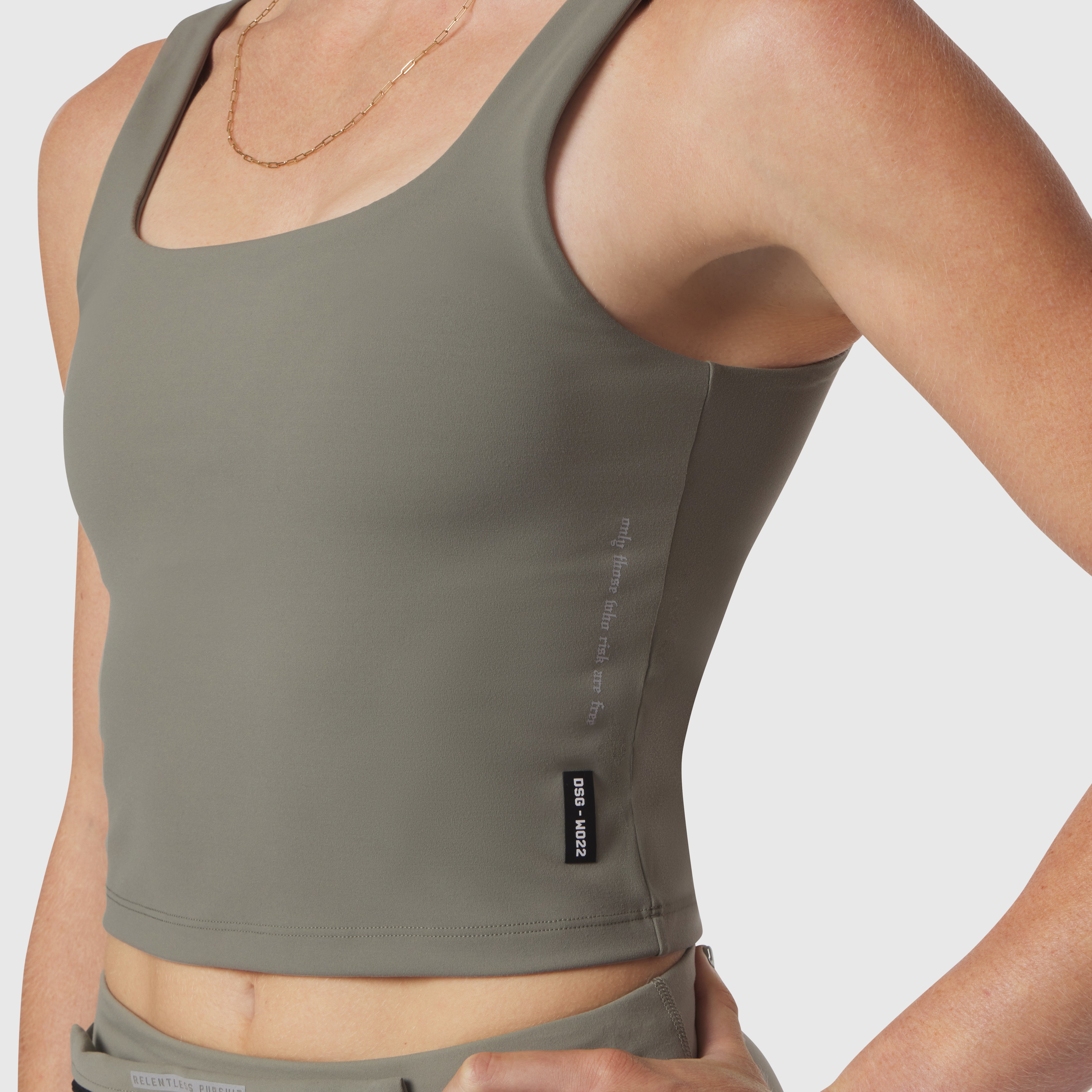 Sage LYCRA 2-in-1 tank top on model, front angled view