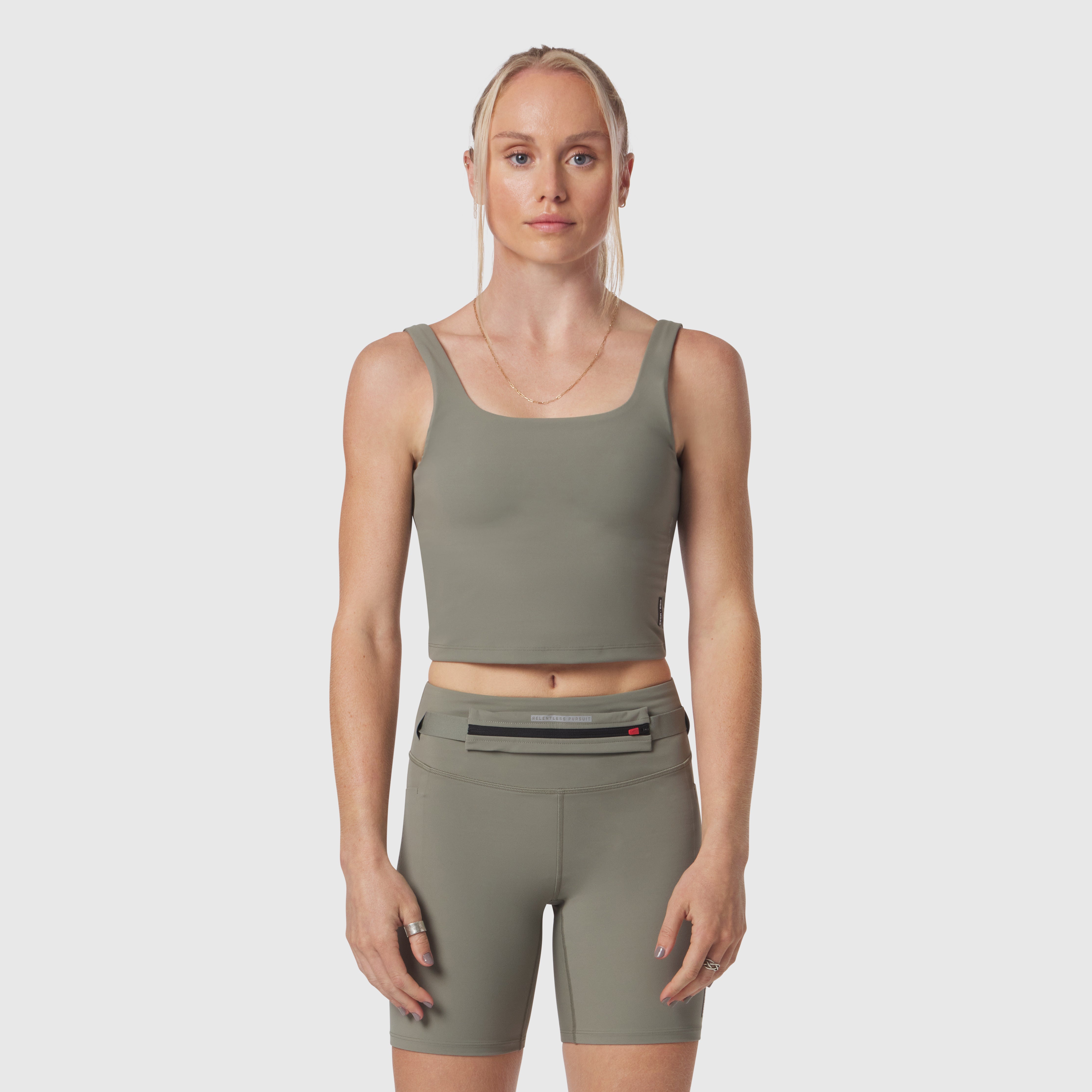 W022 Lycra 2-in-1 tank top in sage, worn by model, front view
