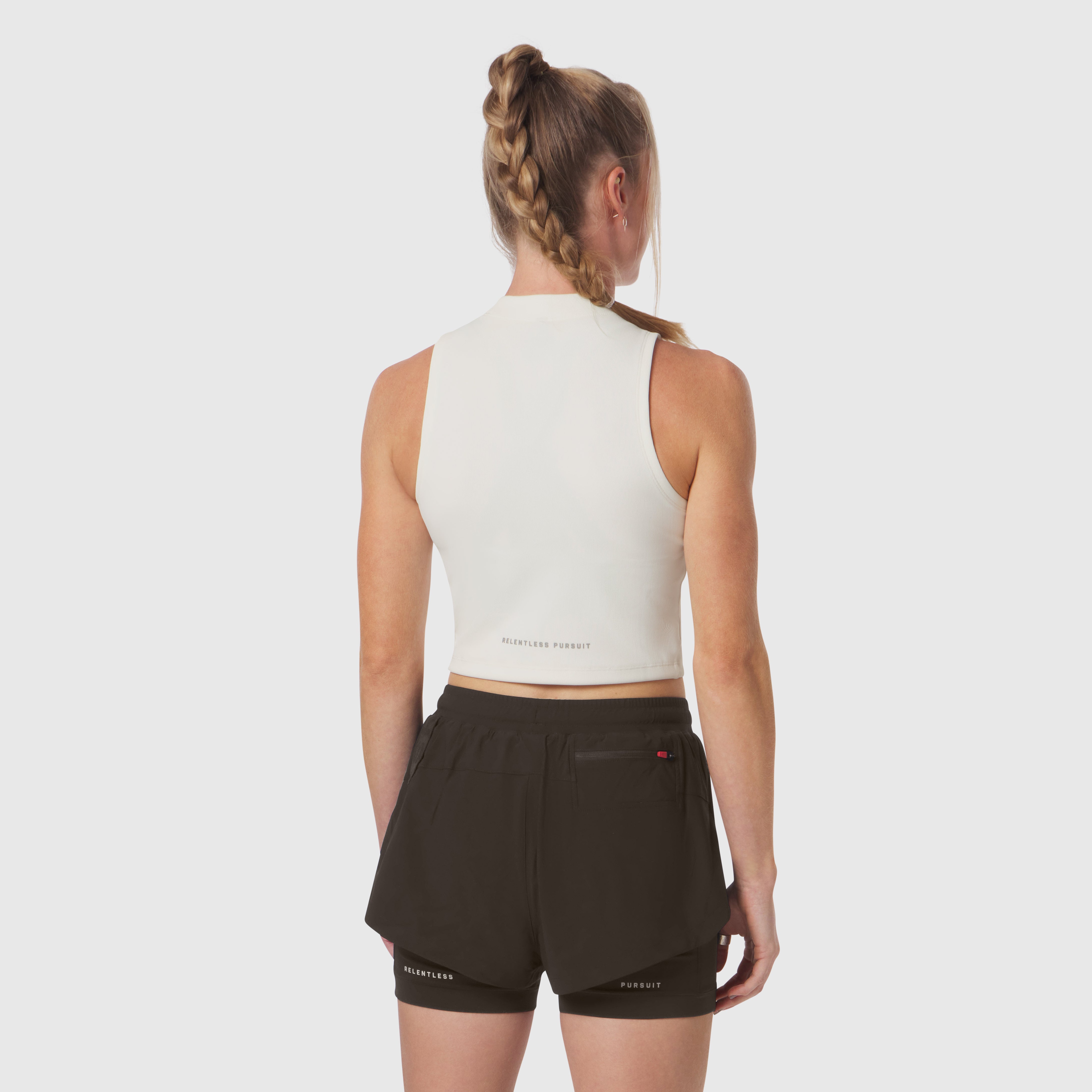Ivory cream ribbed mockneck tank worn with black shorts, back view on model