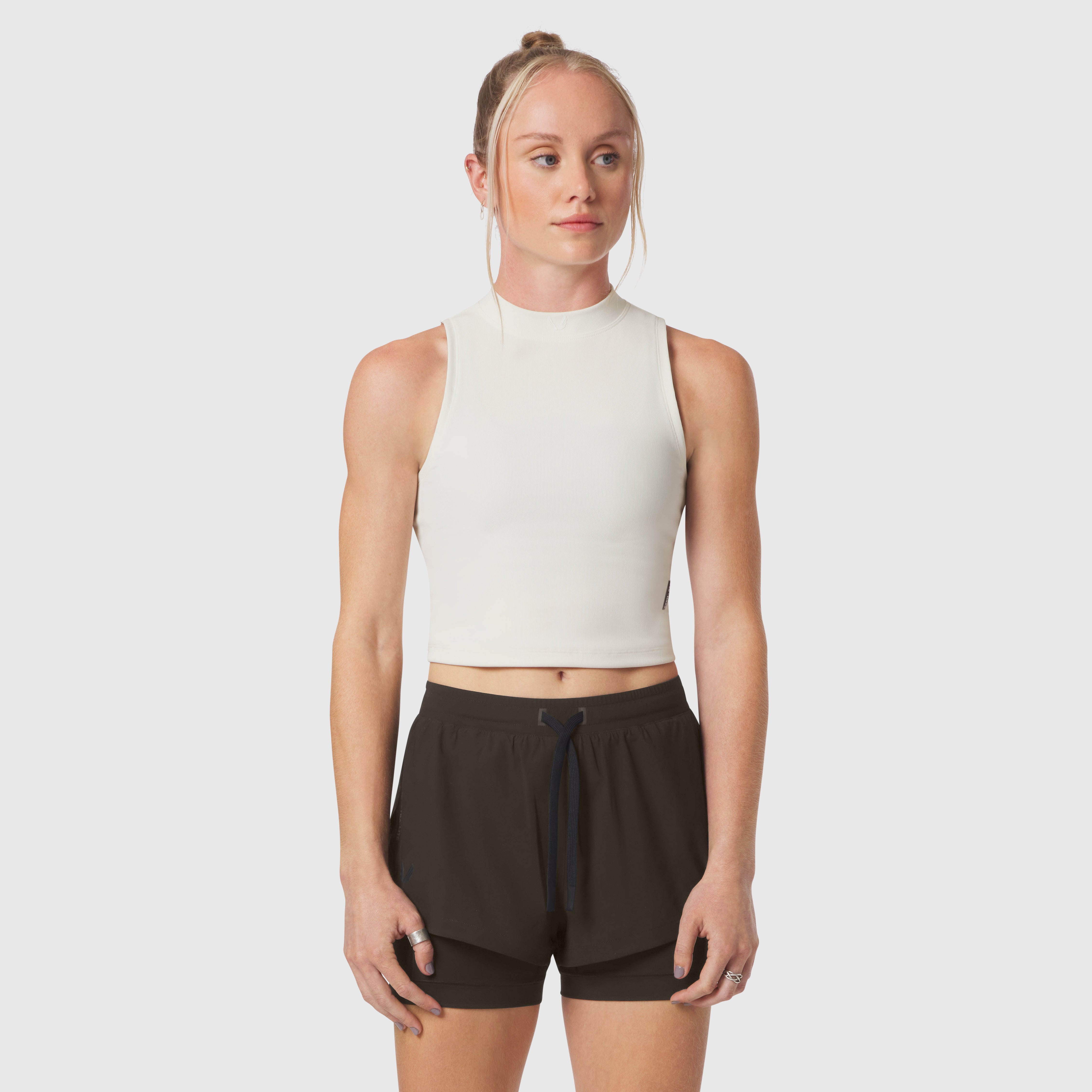Ivory cream ribbed mockneck tank worn with black shorts, front view