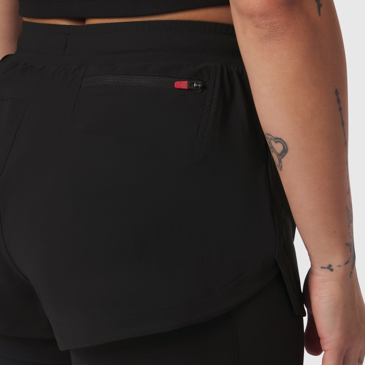 Tetra-Lite Liner Short in black worn by model, side detail view showing pocket