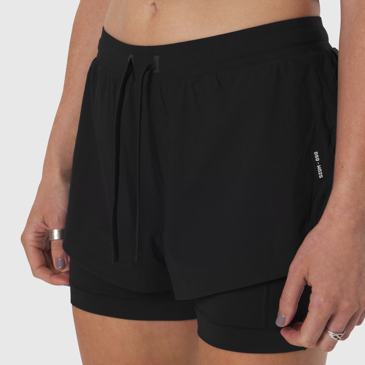 Tetra-Lite Liner Short in black worn by model, side view showing drawstring waistband