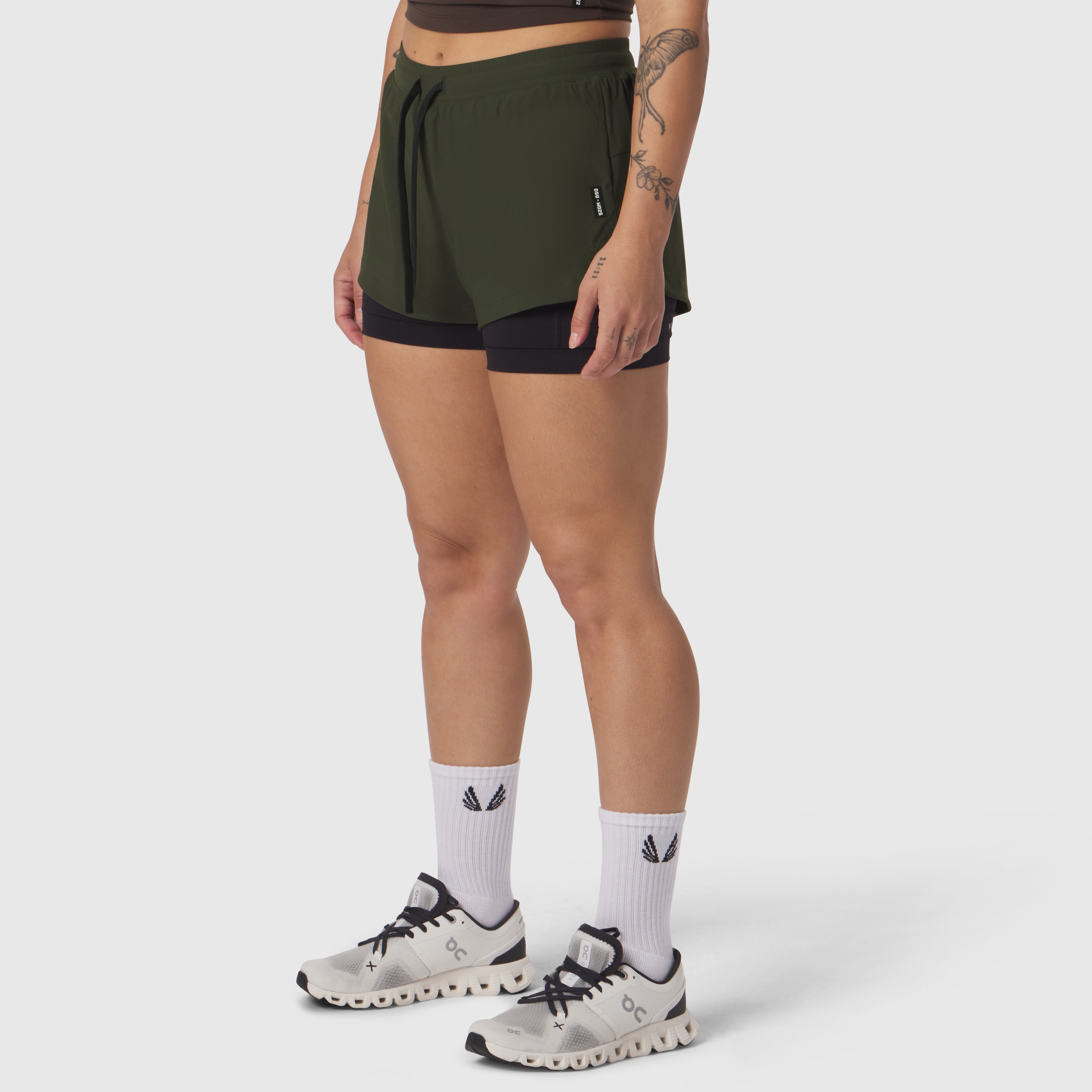 Tetra-Lite Liner Short in olive with black undershorts, modeled with white socks and trail sneakers