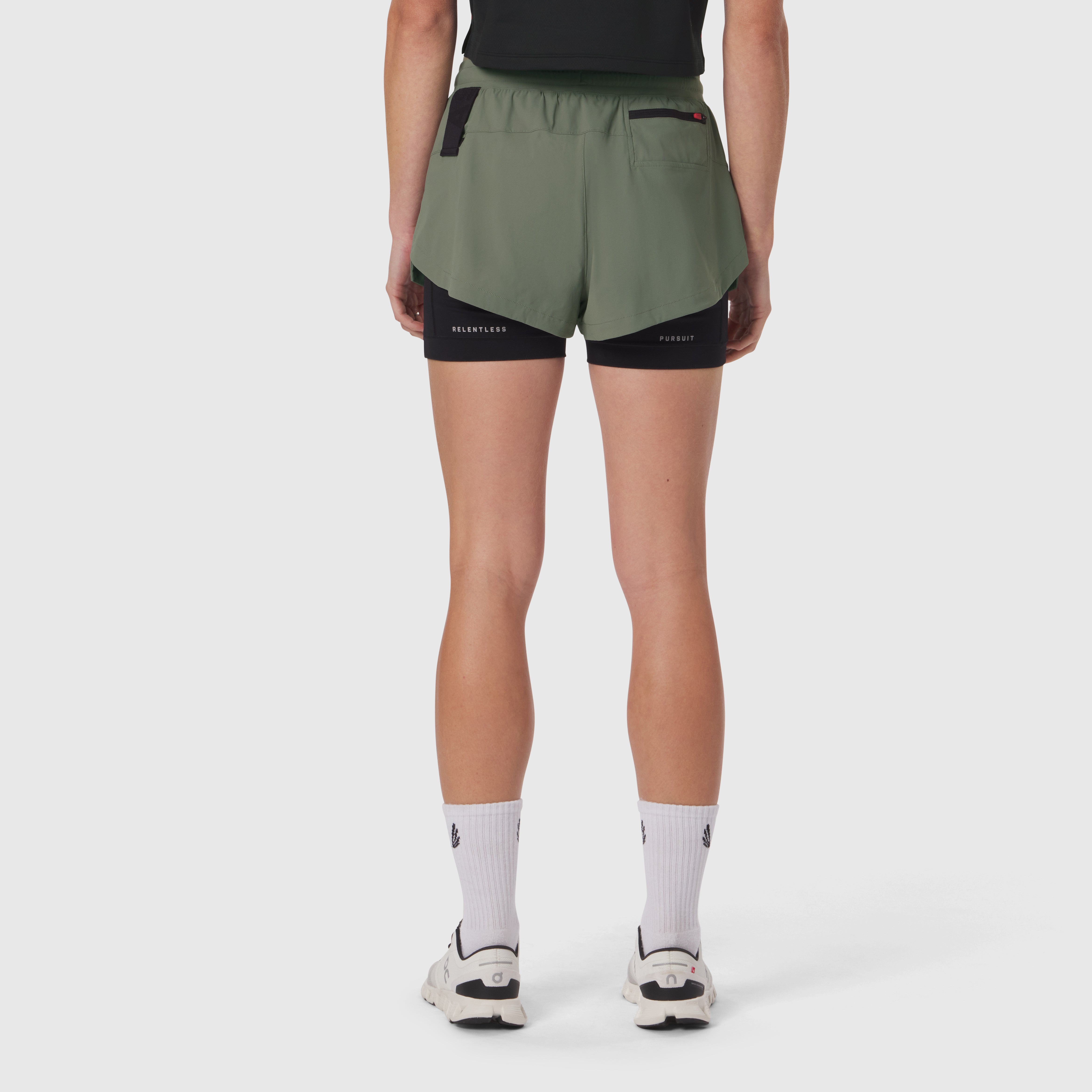 Tetra-Lite Liner Short in sage green with black undershorts, back view on model