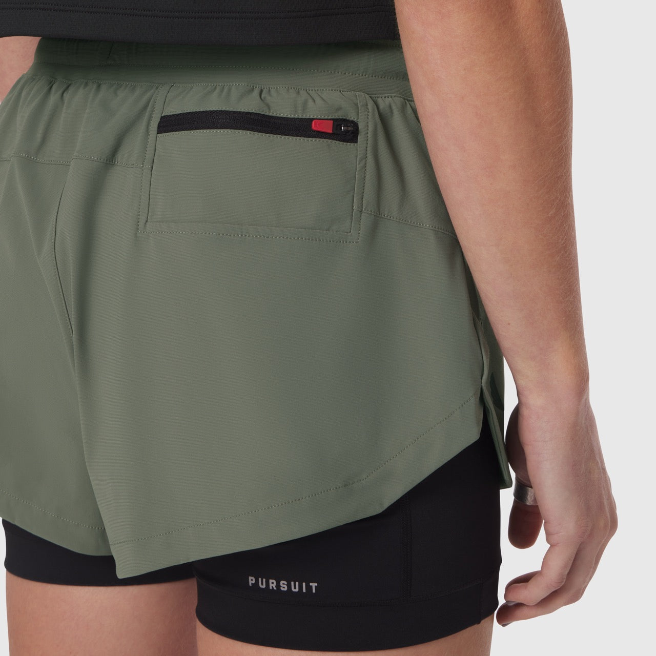 Tetra-Lite Liner Short in sage worn by model, side view showing layered design with black undershorts