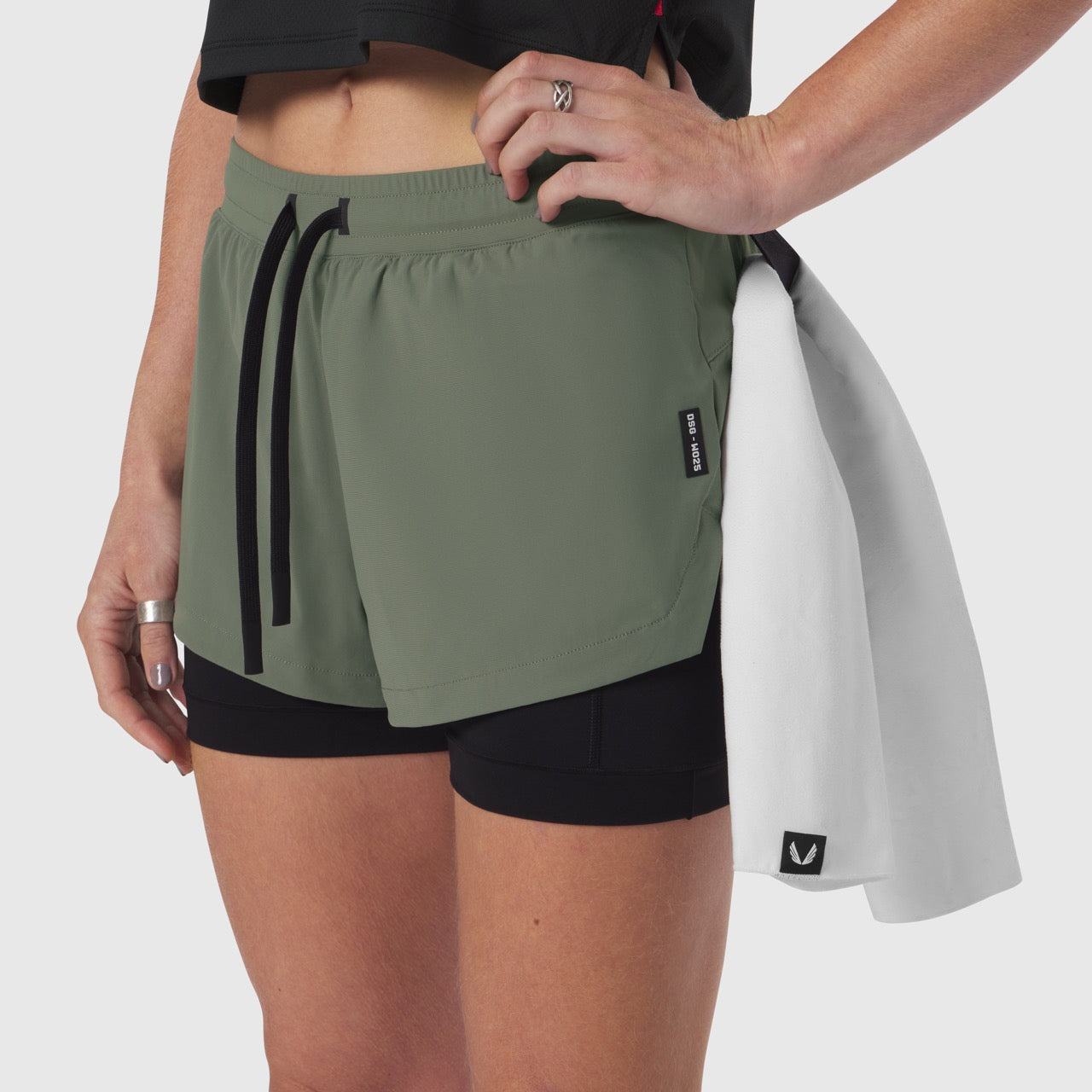 Tetra-Lite® Liner Short in sage green with black undershorts, worn with white jacket draped over shoulder