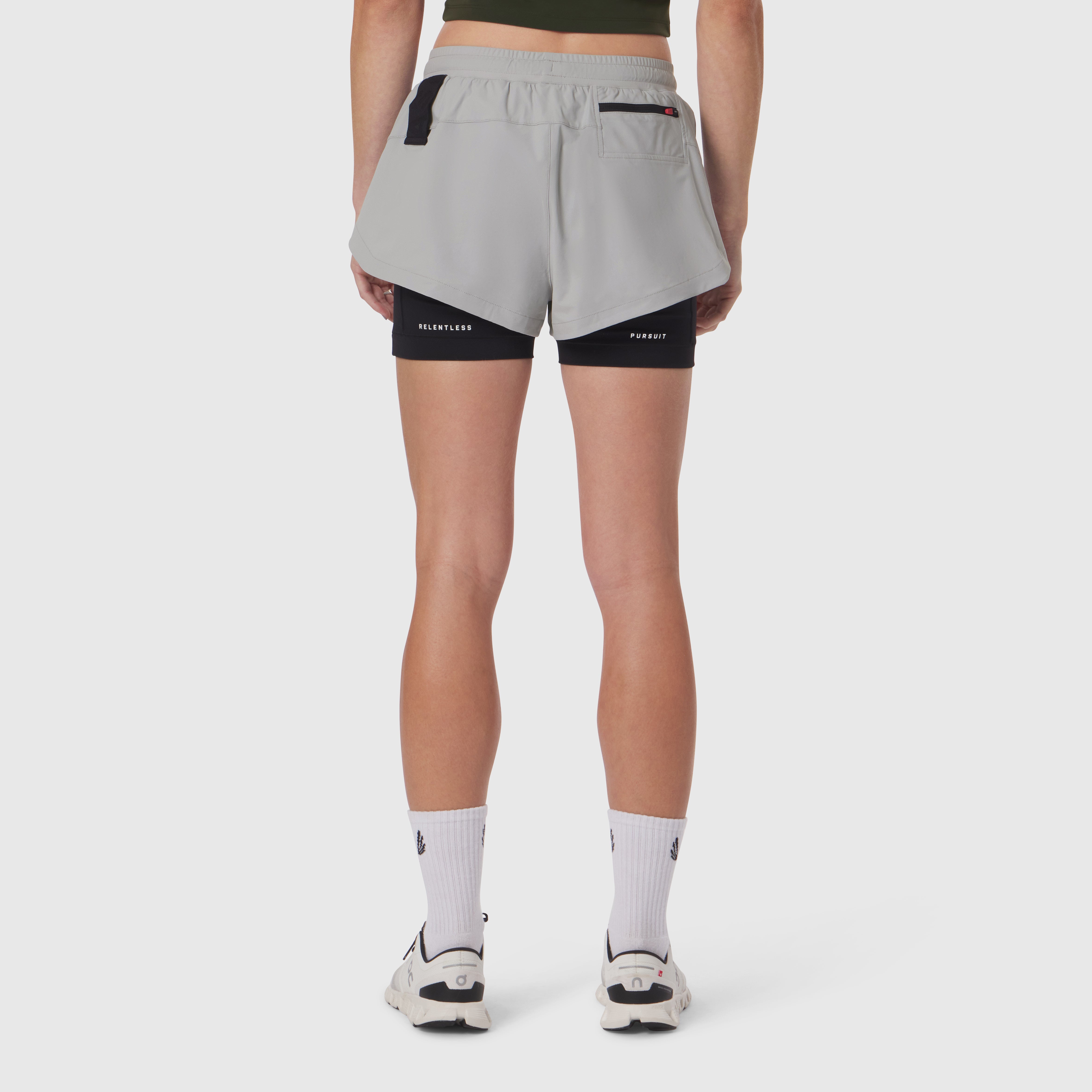 Tetra-Lite Liner Short in slate grey and black, back view on model wearing white socks and sneakers