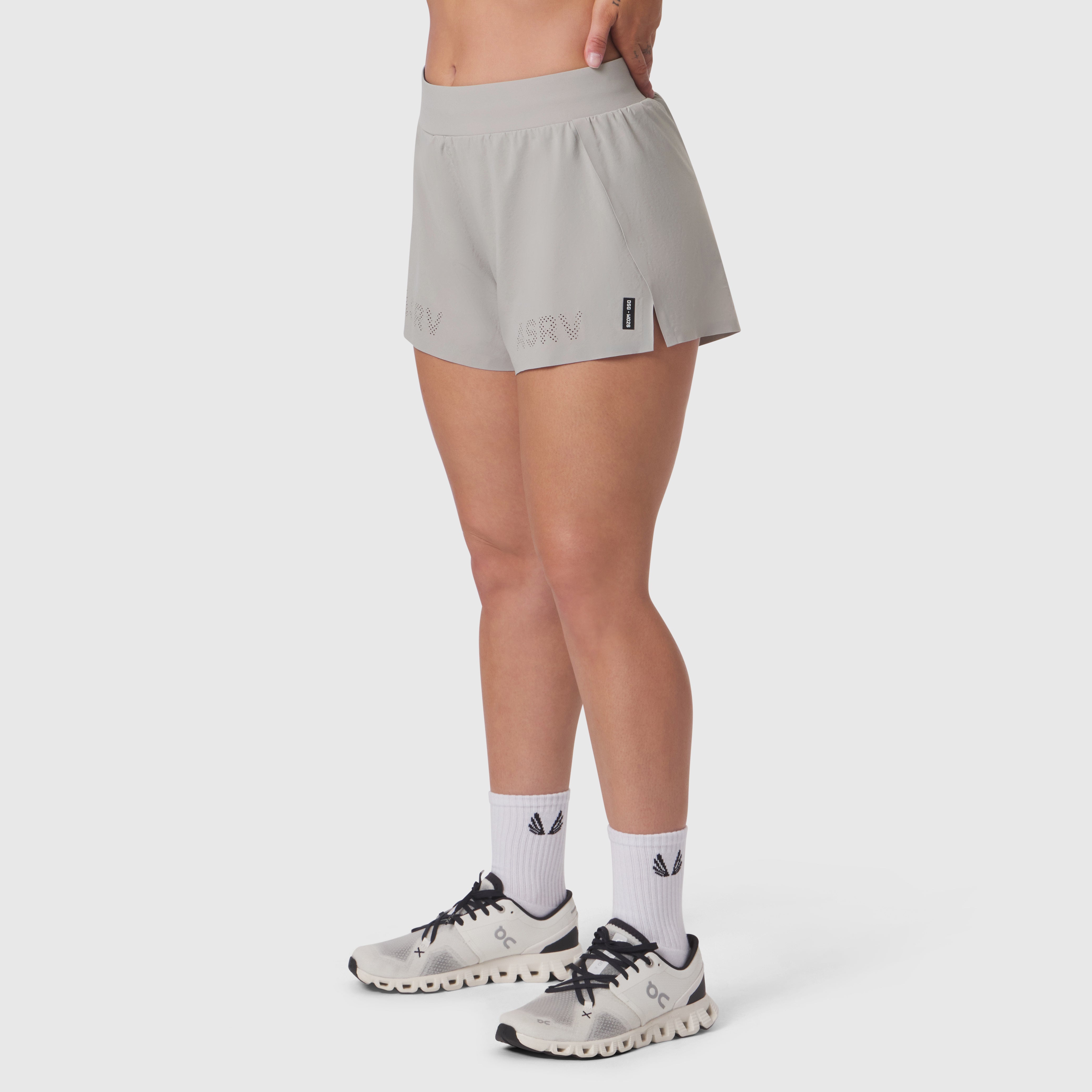 Aerotex Side Split Run Short in slate grey, worn with white socks and running shoes, side view