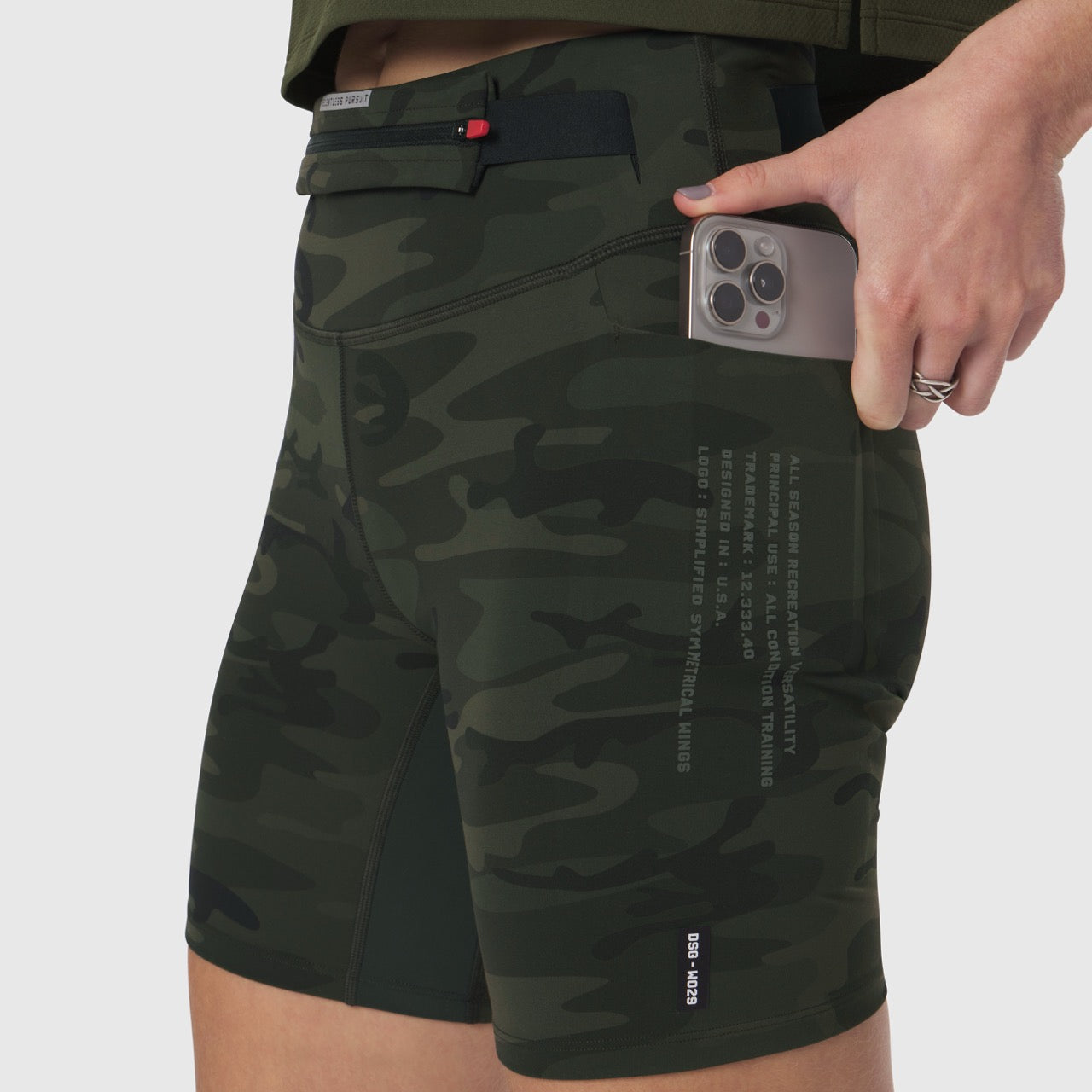 LYCRA® 3-in-1 Biker Short in Dark Camo, model holding phone in pocket