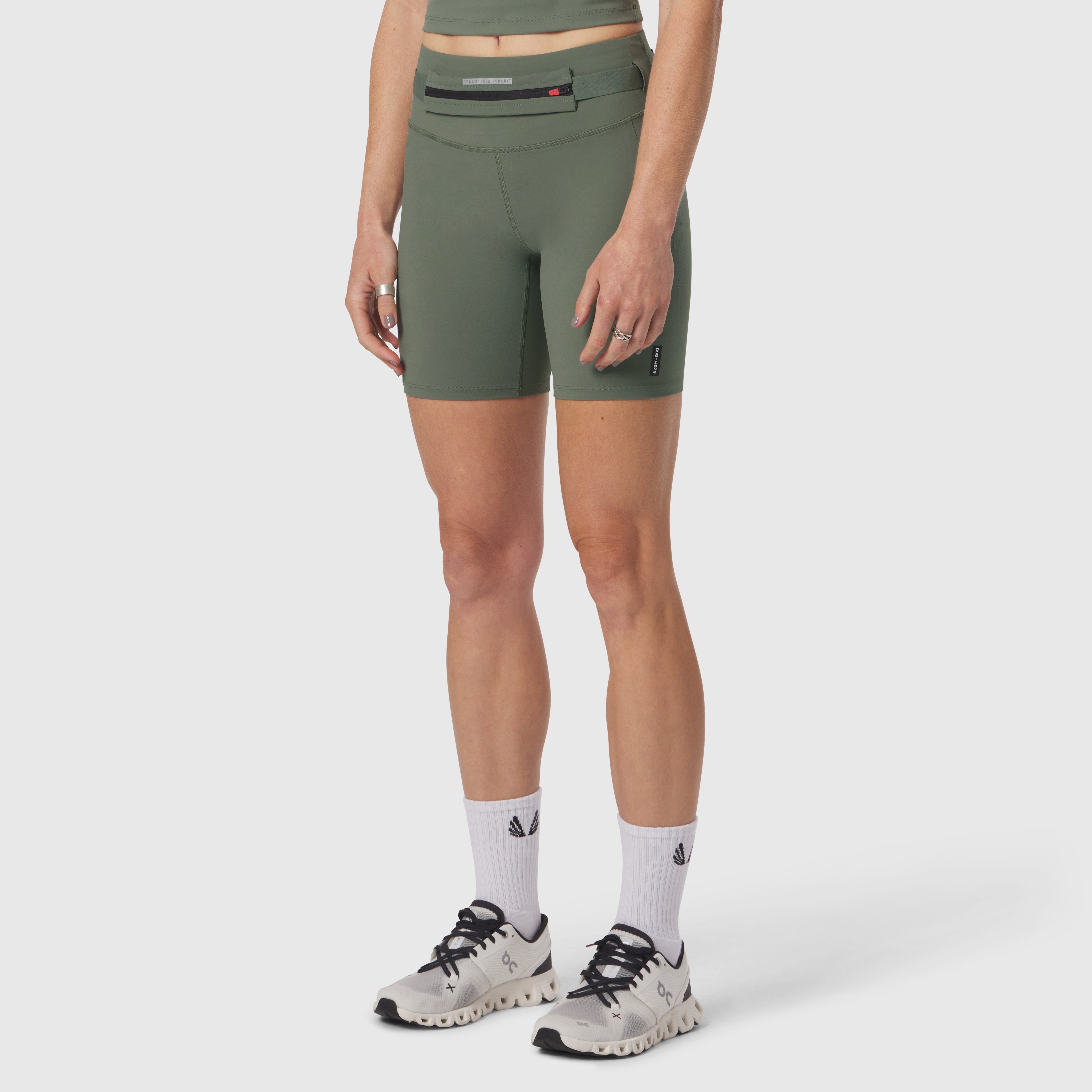 W029 LYCRA® 3-in-1 Biker Short in sage, worn with white socks and athletic shoes