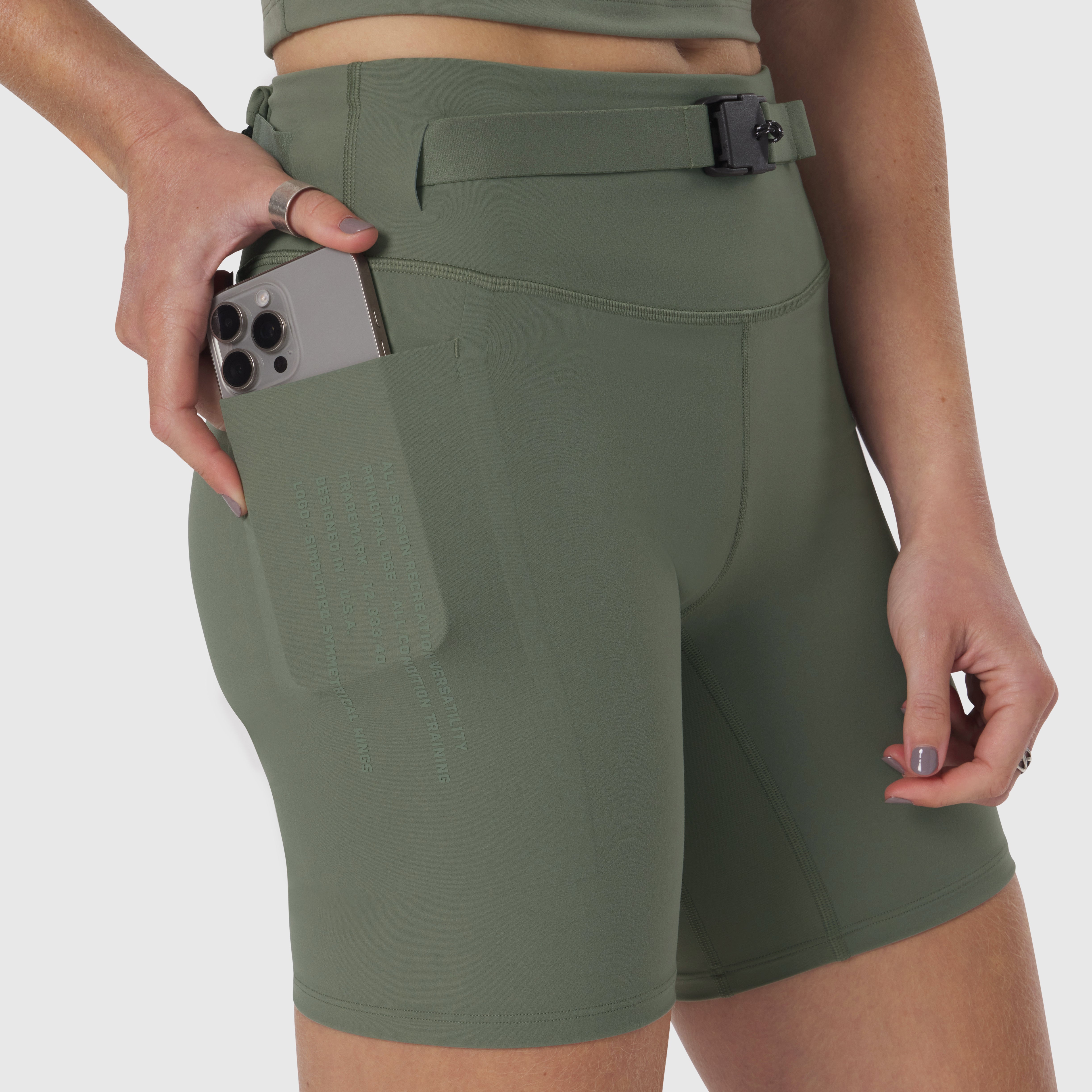 Lycra 3-in-1 biker short in sage, worn by model demonstrating phone pocket functionality