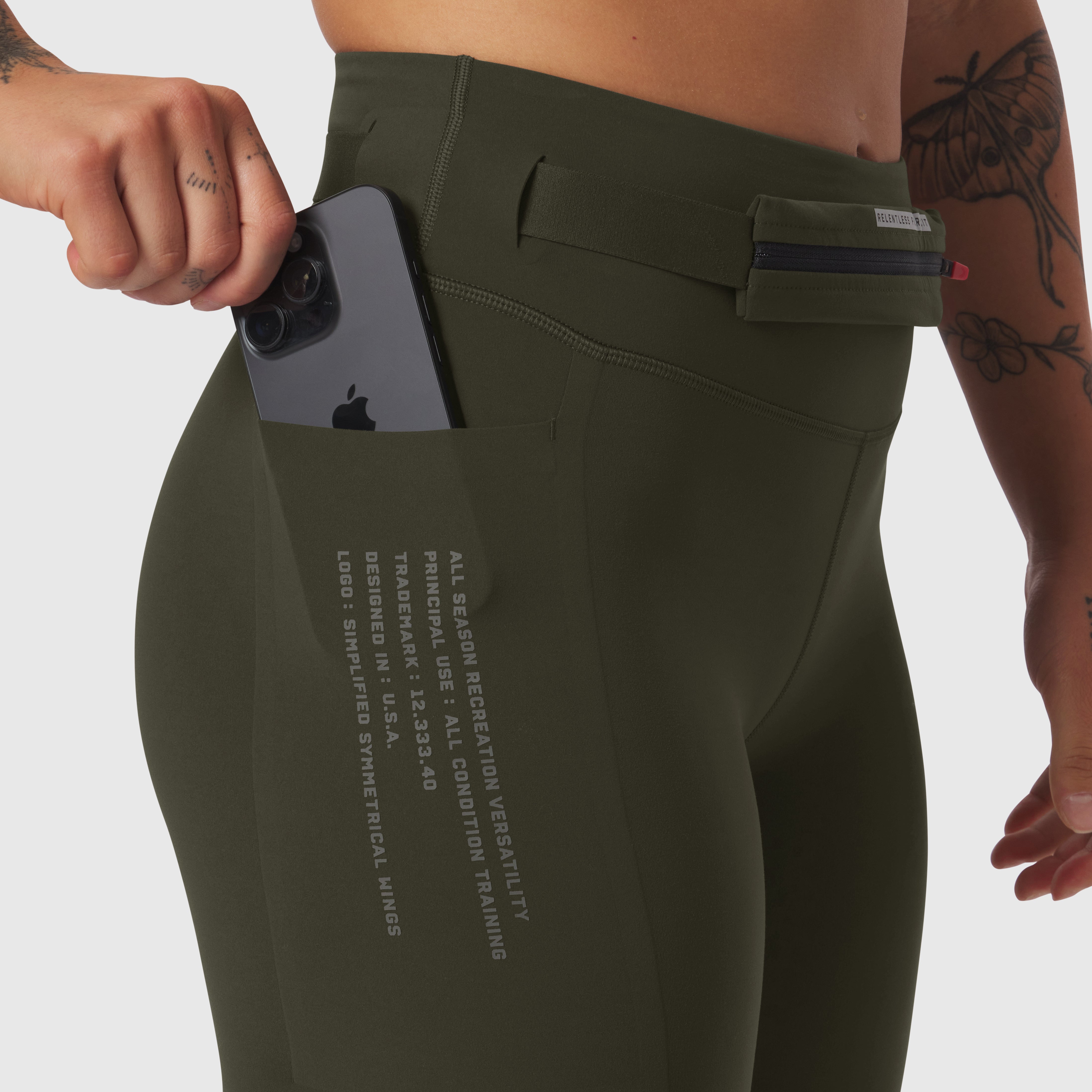 LYCRA® 3-in-1 Legging in olive worn by model, front view with phone in pocket
