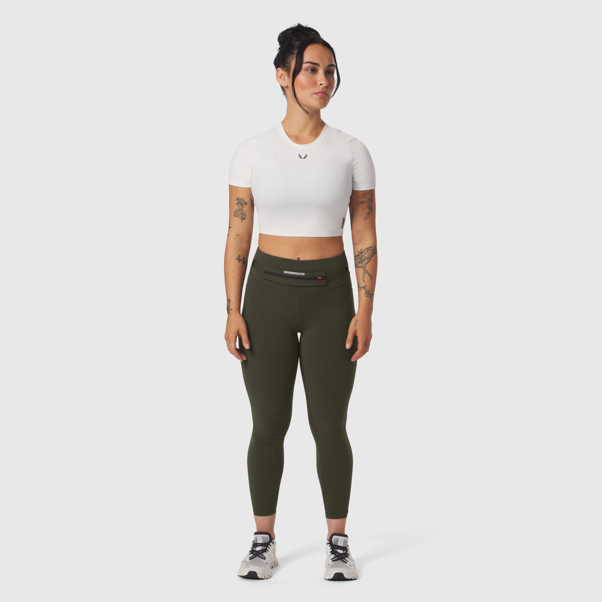 LYCRA® 3-in-1 Legging in olive, worn with white crop top and sneakers, front view