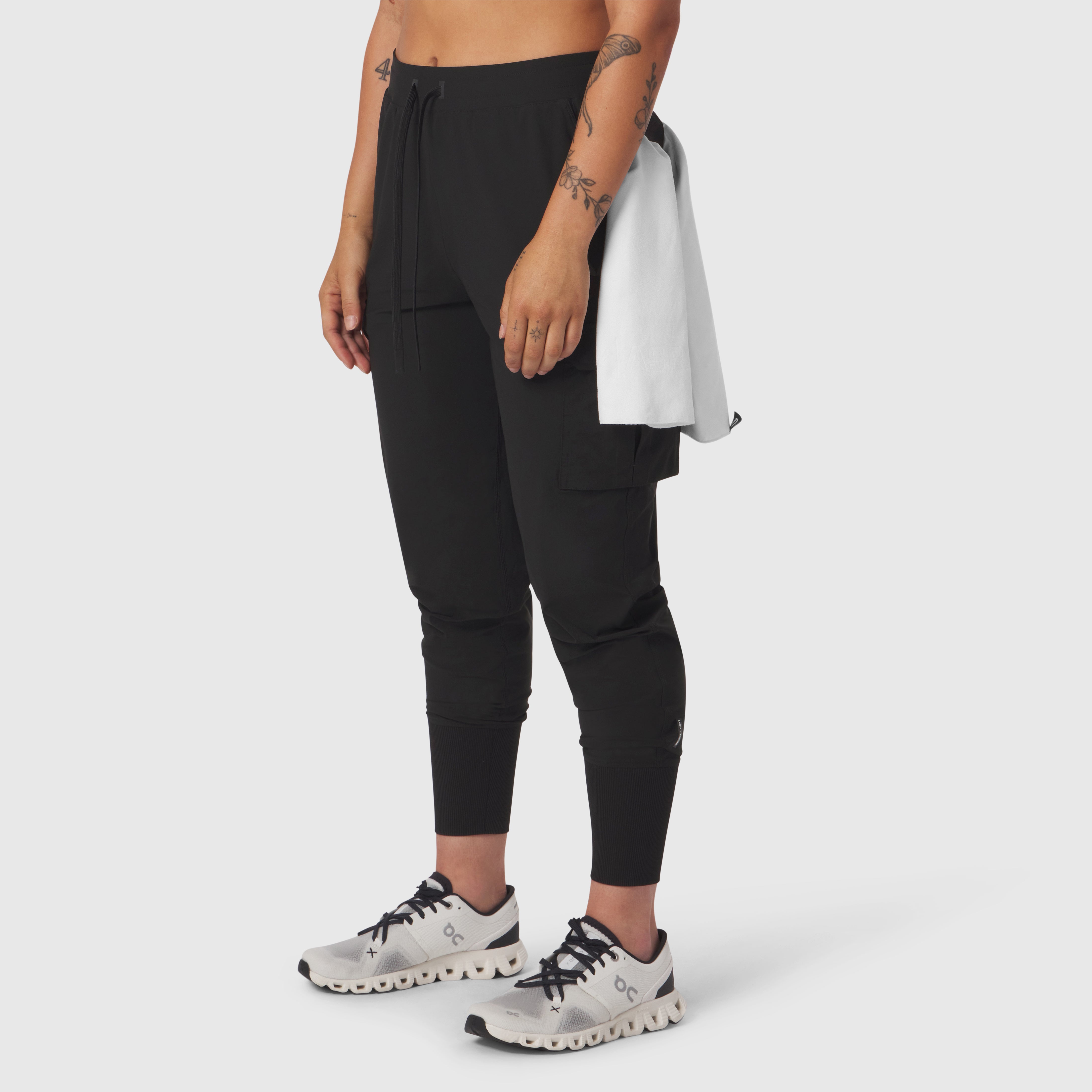 Black Tetra-Lite Cargo High Rib Jogger worn by model, side view with white sneakers
