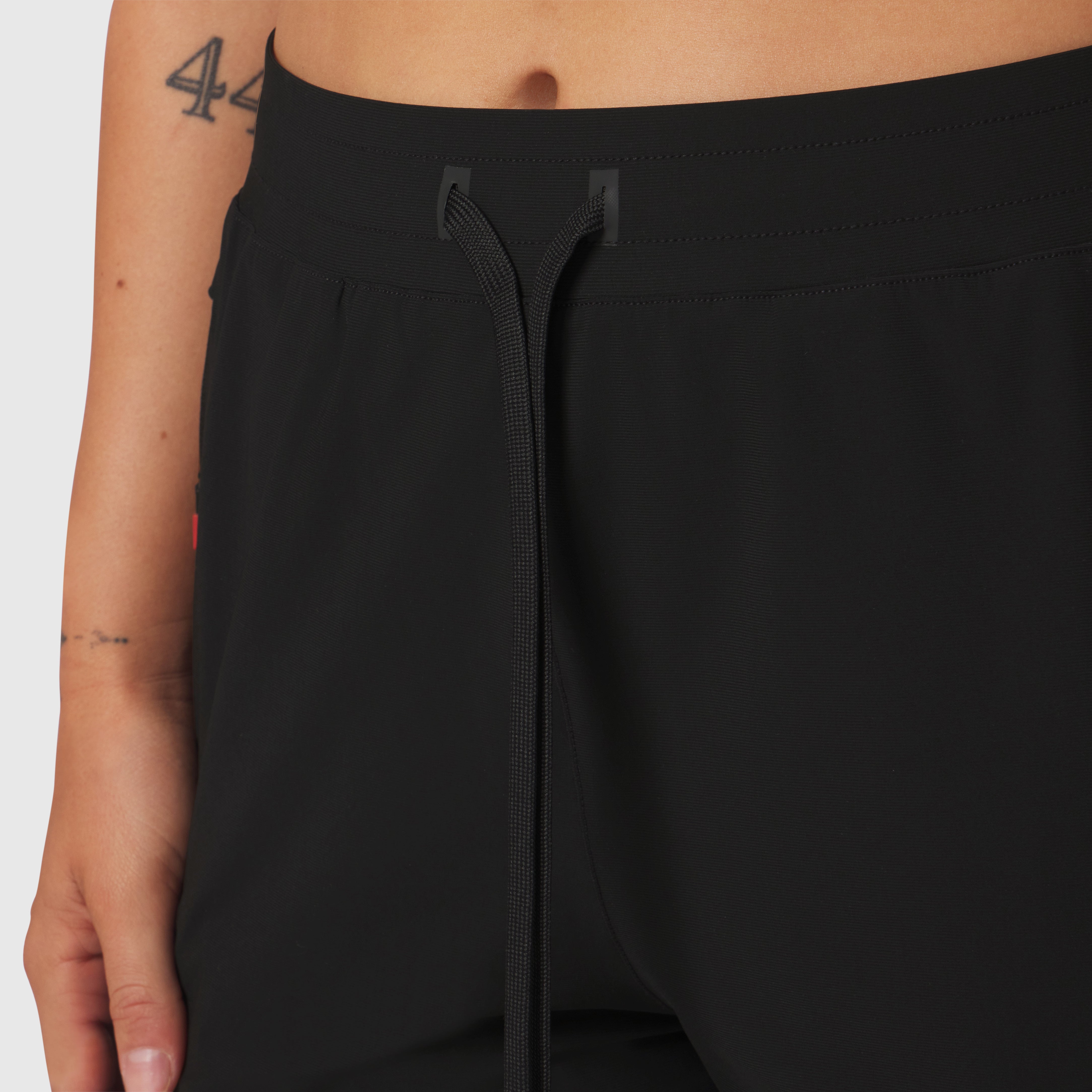 Tetra-Lite Cargo High Rib Jogger in black, worn by model, front detail view