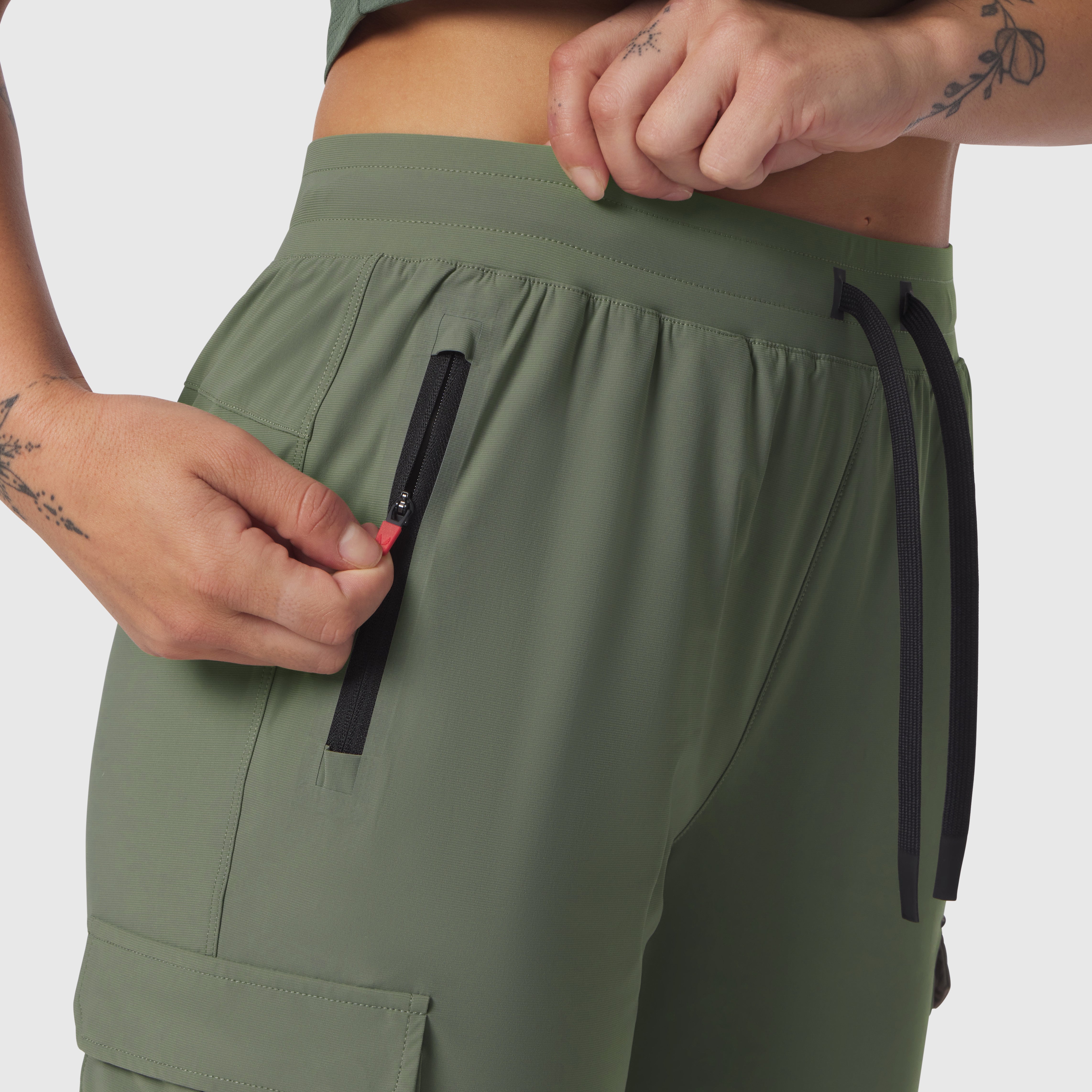 Tetra-Lite Cargo High Rib Jogger in sage, model detail shot of zipper pockets