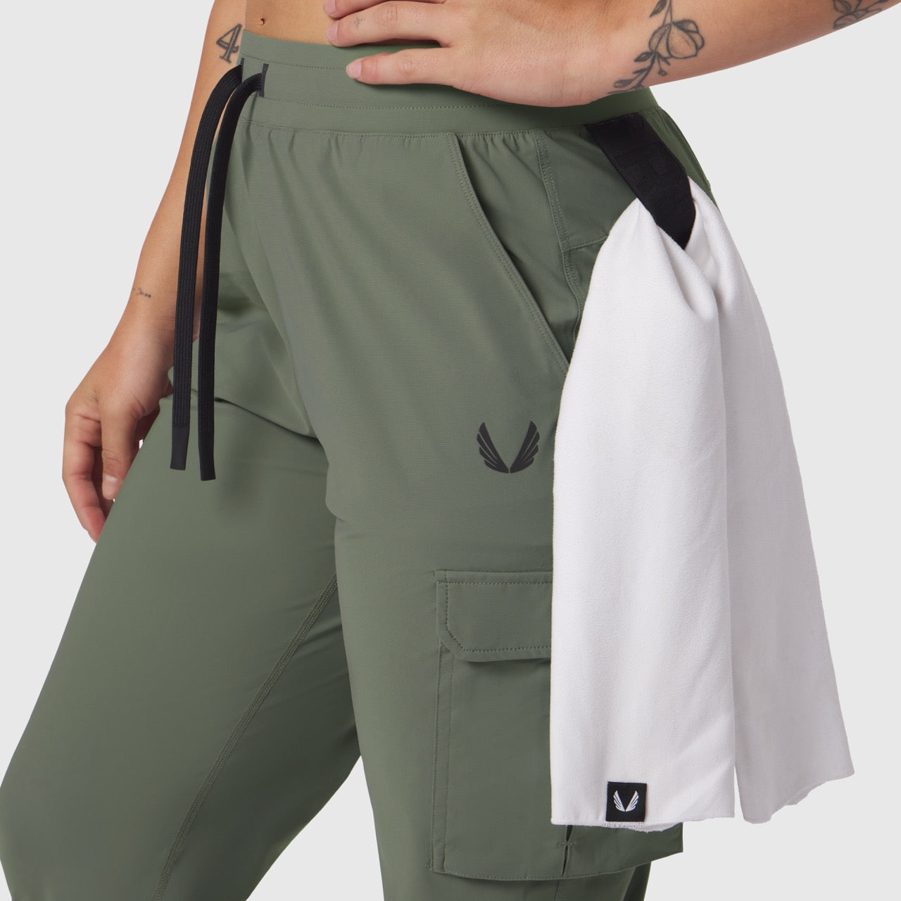 Tetra-Lite Cargo High Rib Jogger in sage with white color-block panel, worn by model