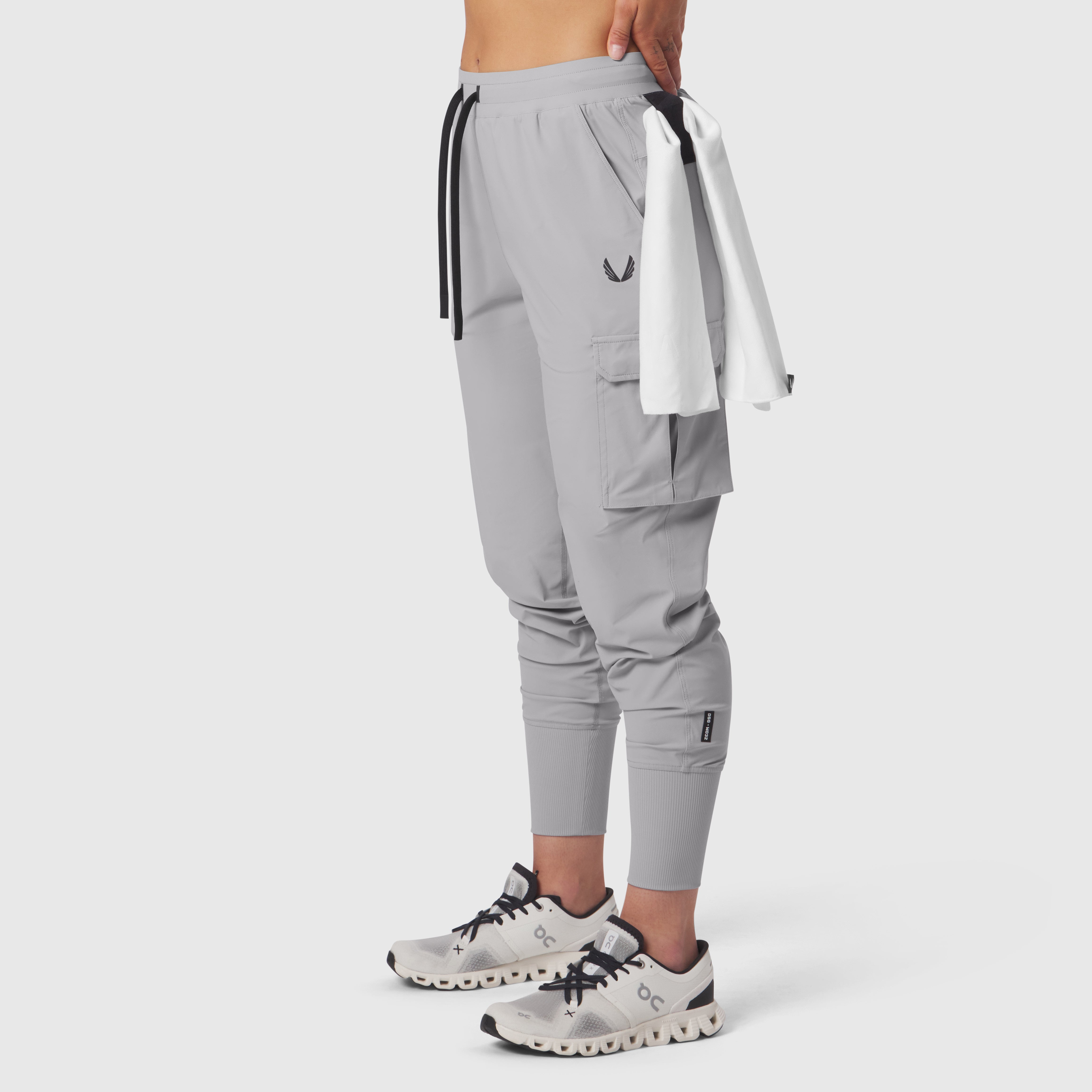Tetra-Lite Cargo High Rib Jogger in slate grey, worn with towel accessory, side view