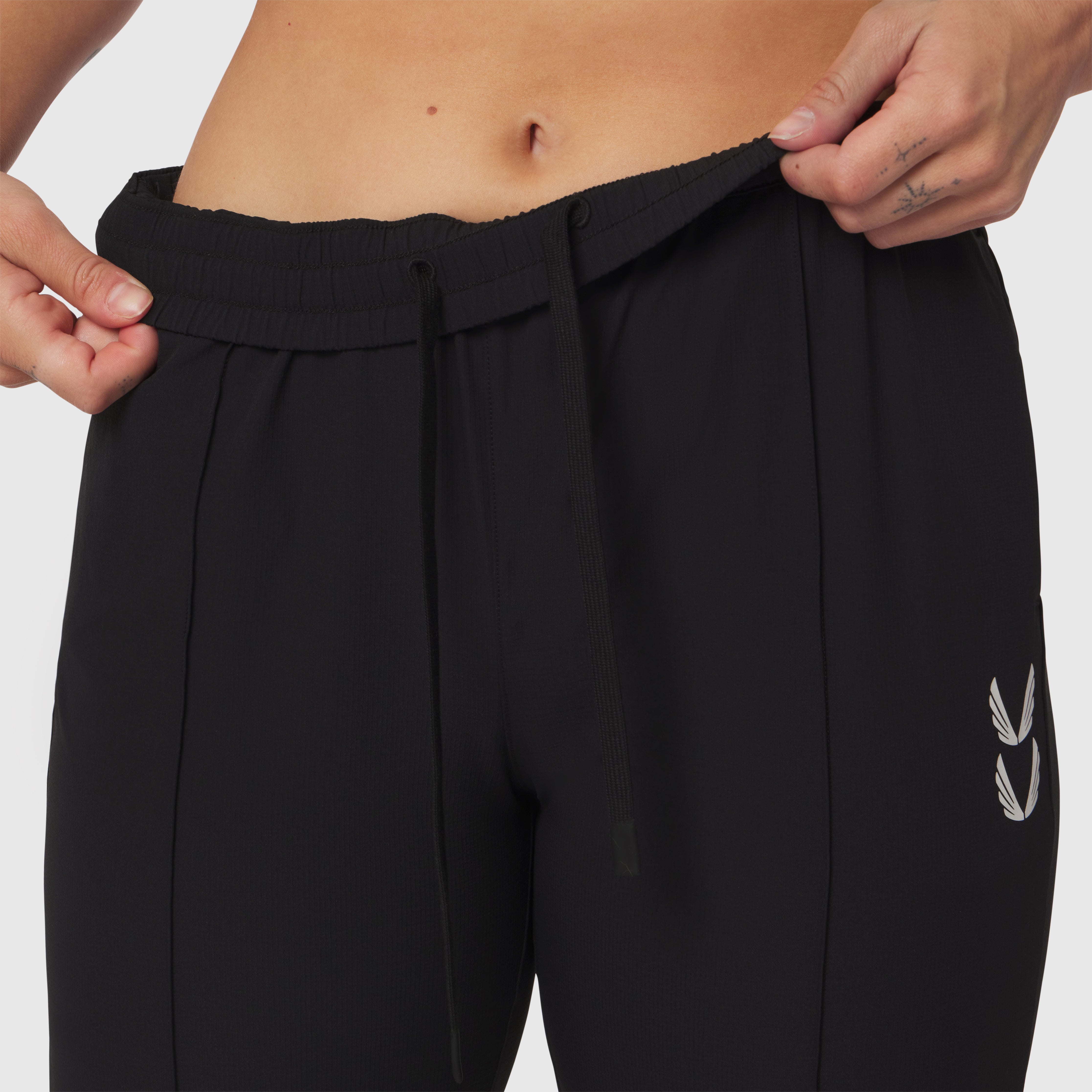 Black ripstop relaxed track pant worn by model, waistband detail view