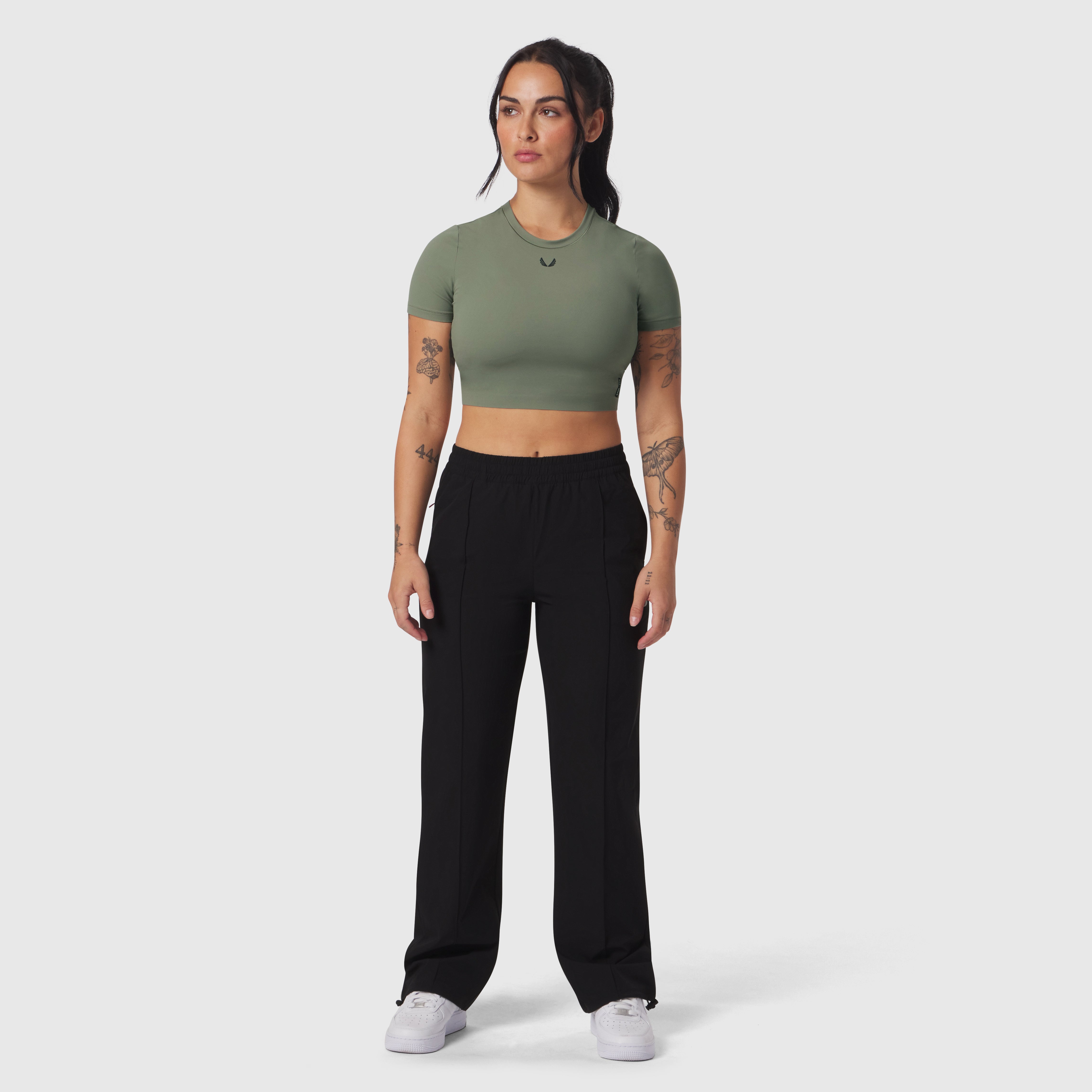 Ripstop Relaxed Track Pant in black, worn with sage green crop top, front standing pose