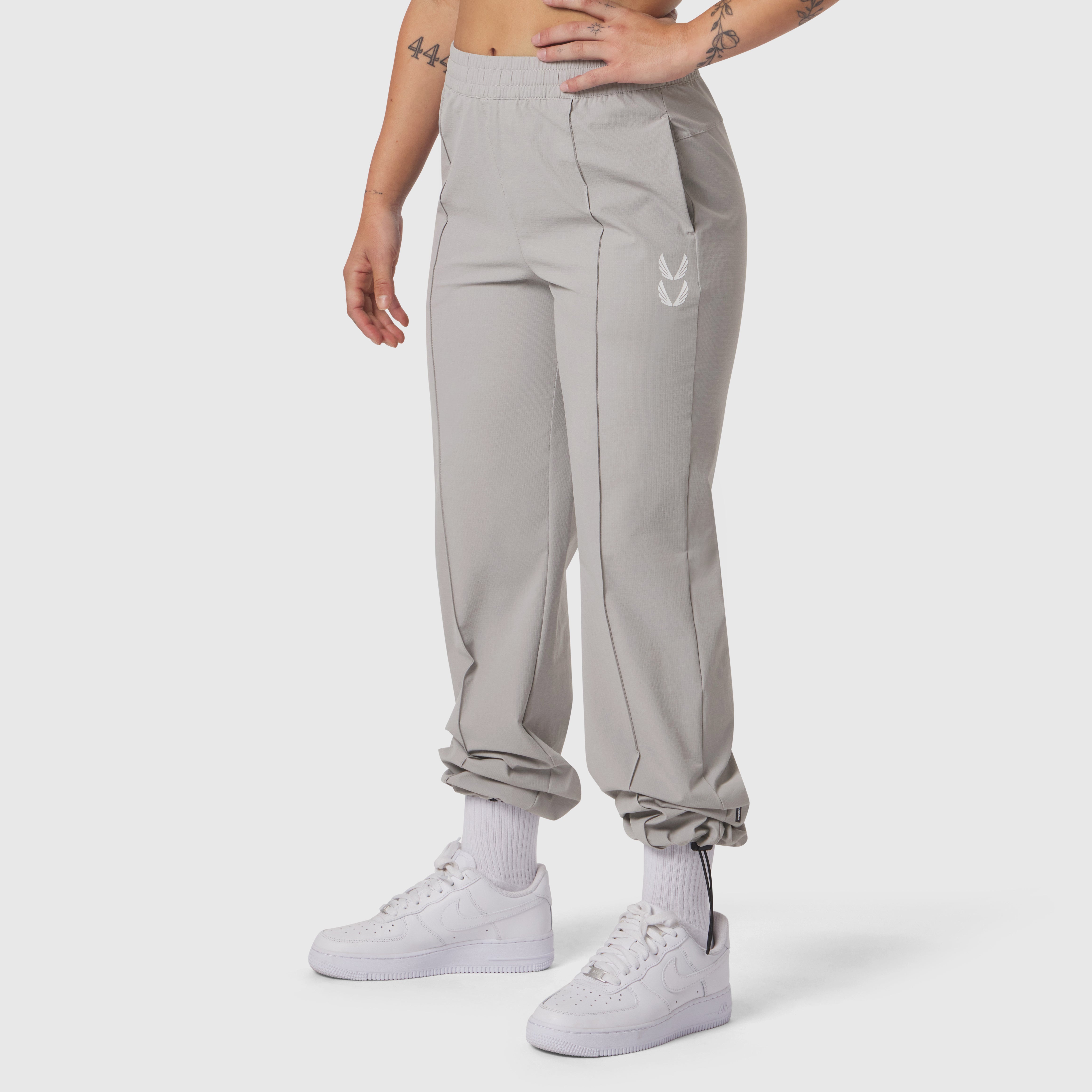 W036 Ripstop Relaxed Track Pant in slate grey, worn with white socks and sneakers, front view