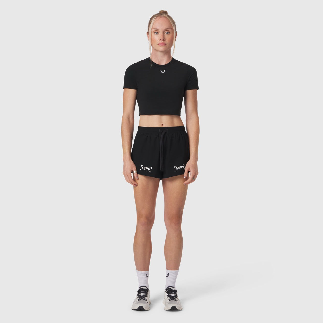 W037 Tetra-Lite Linerless Short in black with bracket logo, worn by model, front view