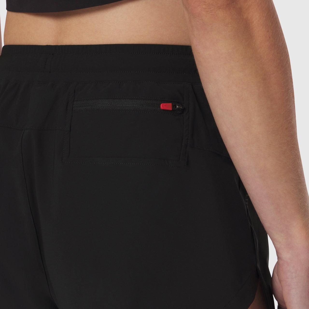 Tetra-Lite Linerless Short in black worn by model, side detail view showing pocket