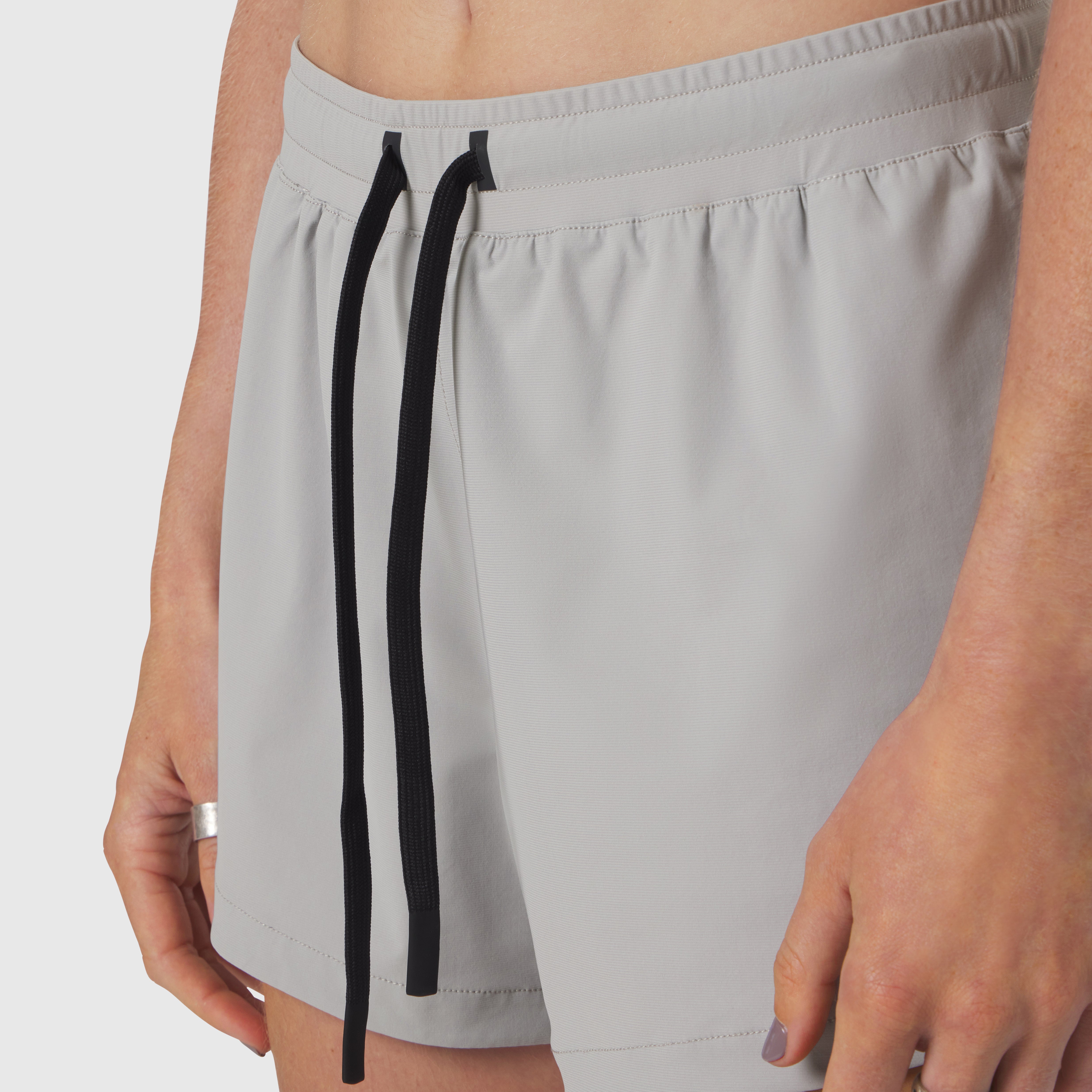 Tetra-Lite Linerless Short in slate grey worn by model, front view with drawstring detail