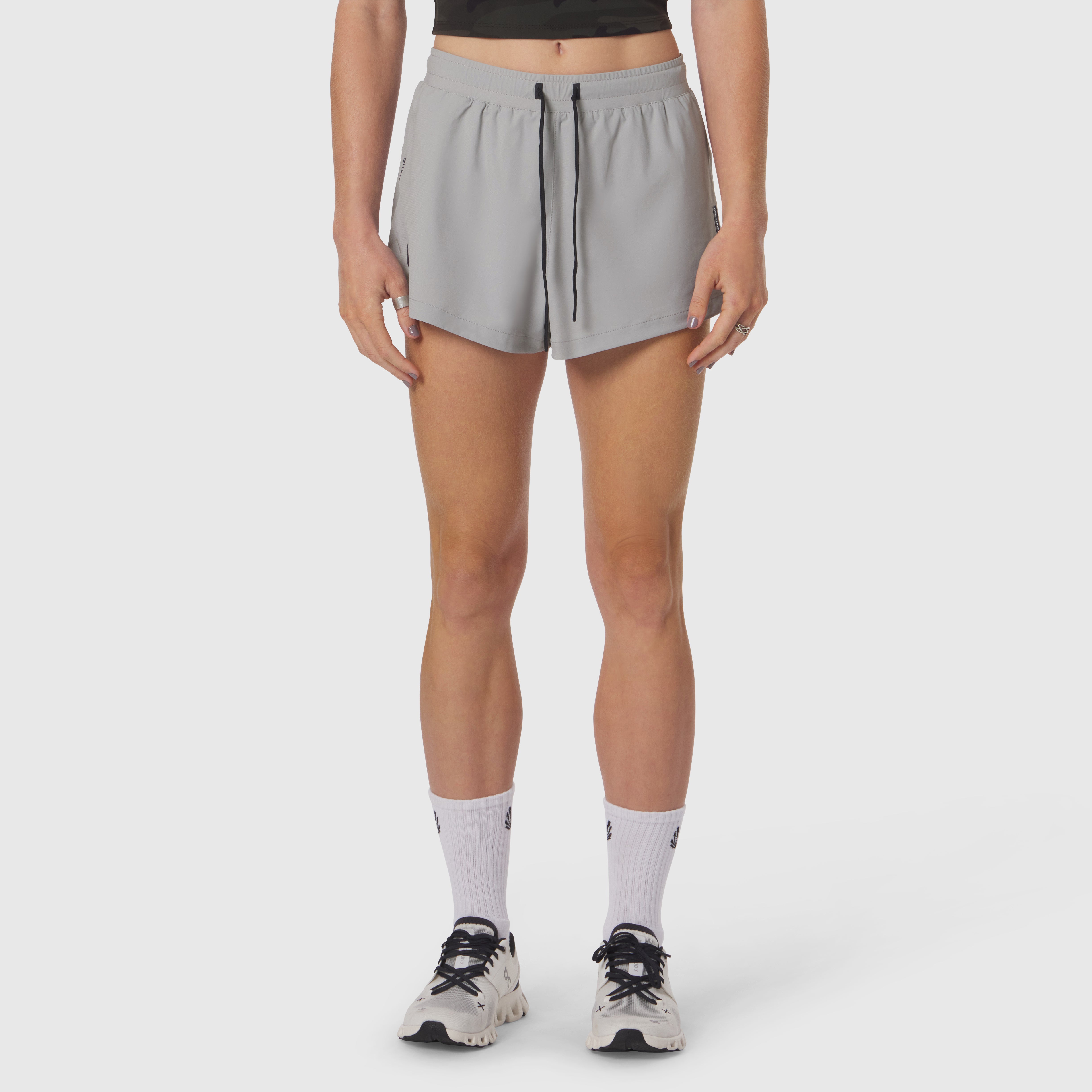 Tetra-Lite Linerless Short in slate grey, worn with white socks and sneakers, front view