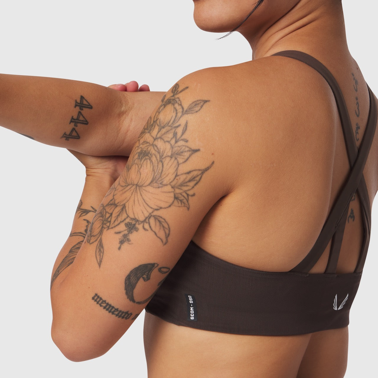 Dark Earth Lycra Hybrid Sports Bra worn by model showing back view and tattoos