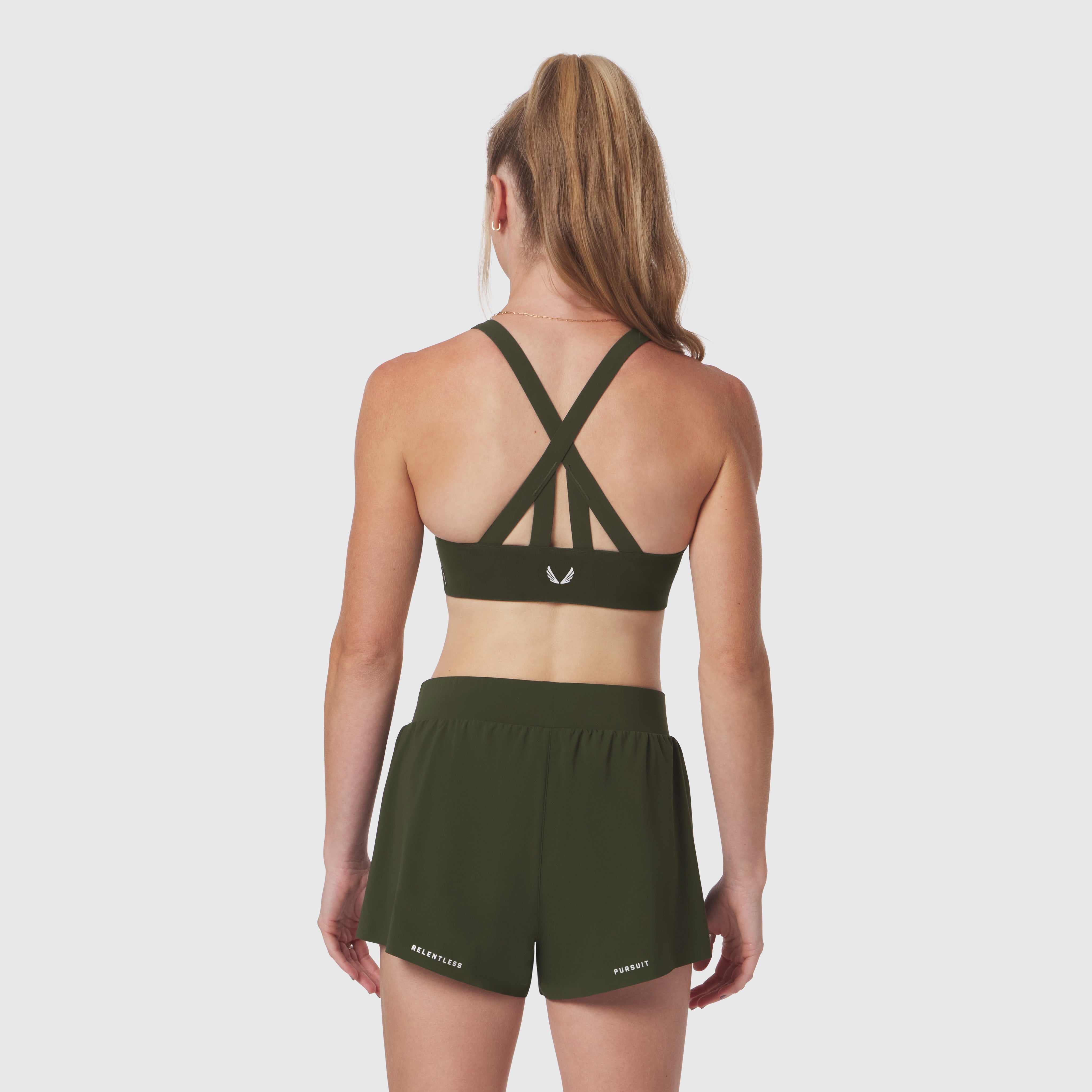 LYCRA® Hybrid Sports Bra in olive, back view on model showing strappy back design