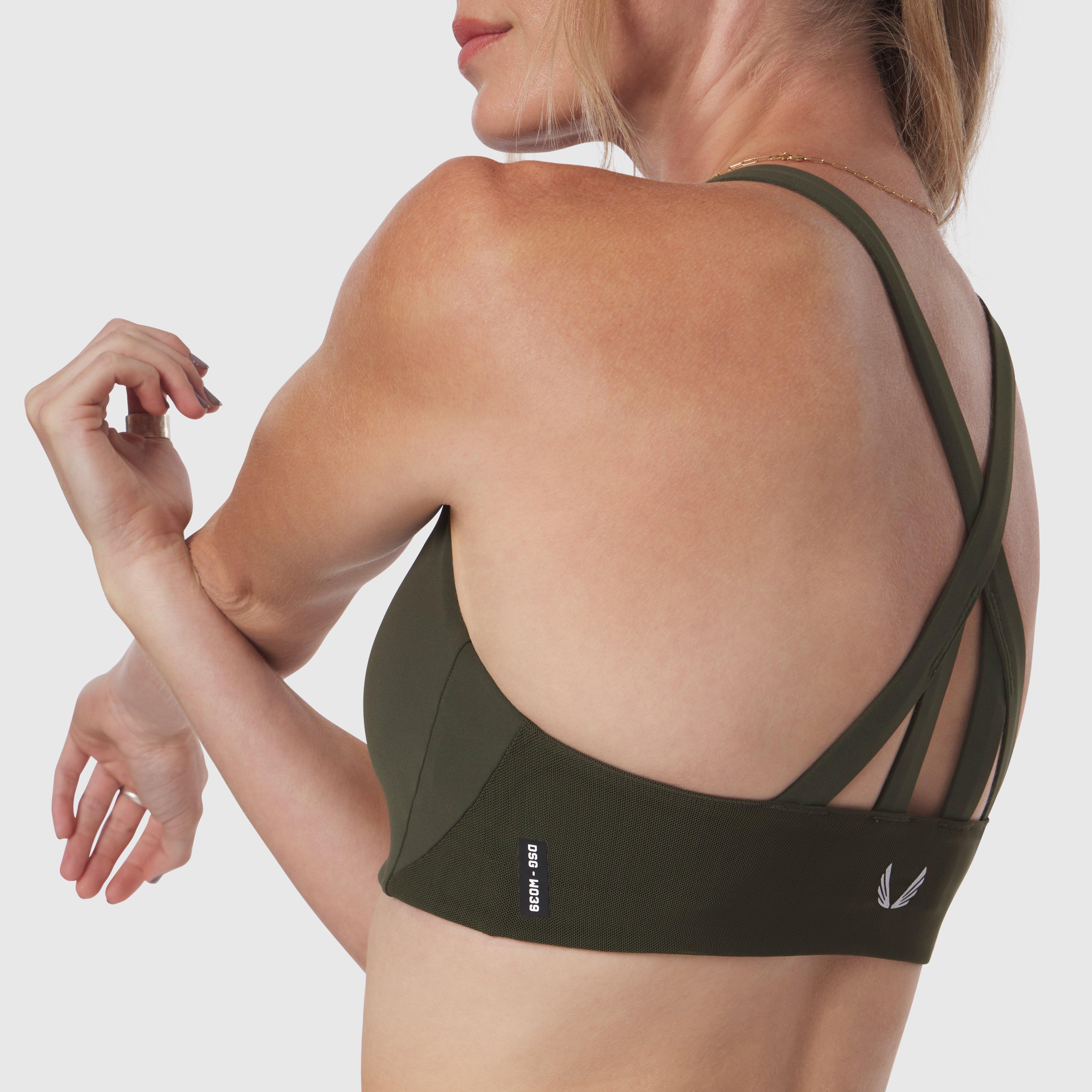 Olive LYCRA® Hybrid Sports Bra worn by model, back view showing open back design