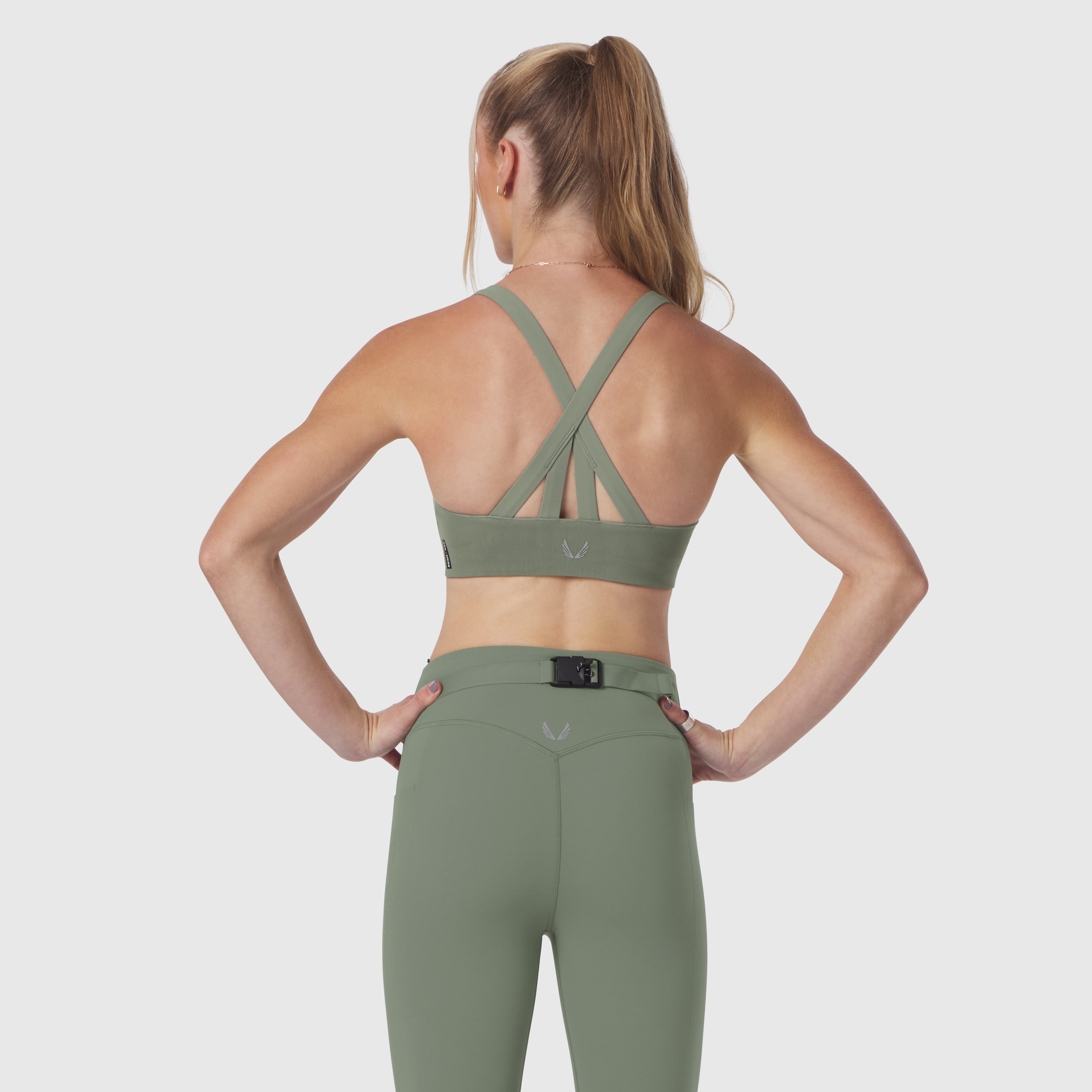 Sage LYCRA® Hybrid Sports Bra worn by model, back view showing strappy cross-back design
