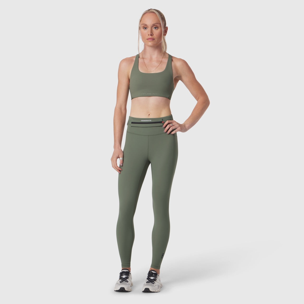 Lycra Hybrid Sports Bra in sage, worn by model with matching leggings, front view