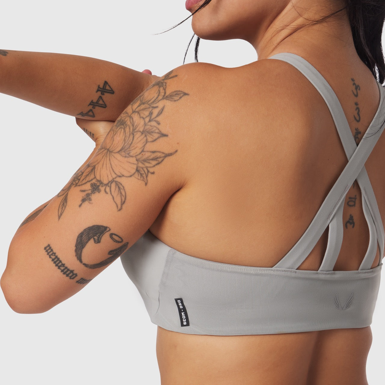 Lycra Hybrid Sports Bra in slate grey, worn by model showing back view and side profile